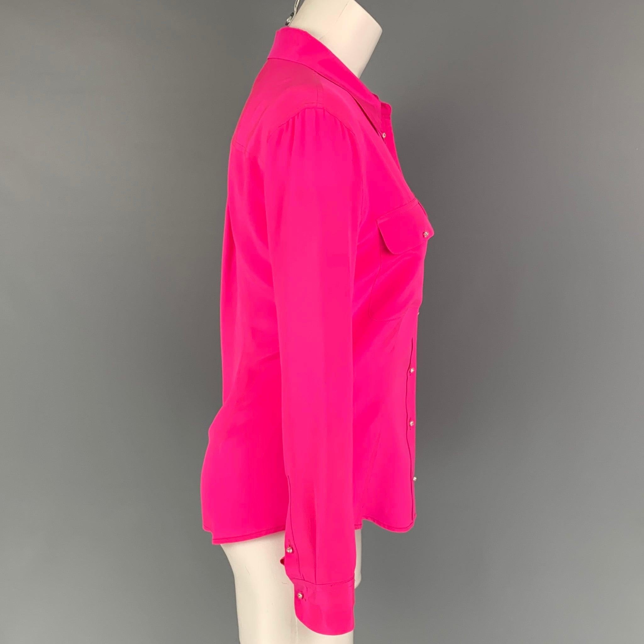EQUIPMENT shirt coms in a pink silk featuring rhinestone buttons, flap pockets, and a spread collar.
Very Good
Pre-Owned Condition. 

Marked:   S 

Measurements: 
 
Shoulder: 16 inches  Bust: 35 inches  Sleeve: 24 inches  Length: 25 inches 
  
  
