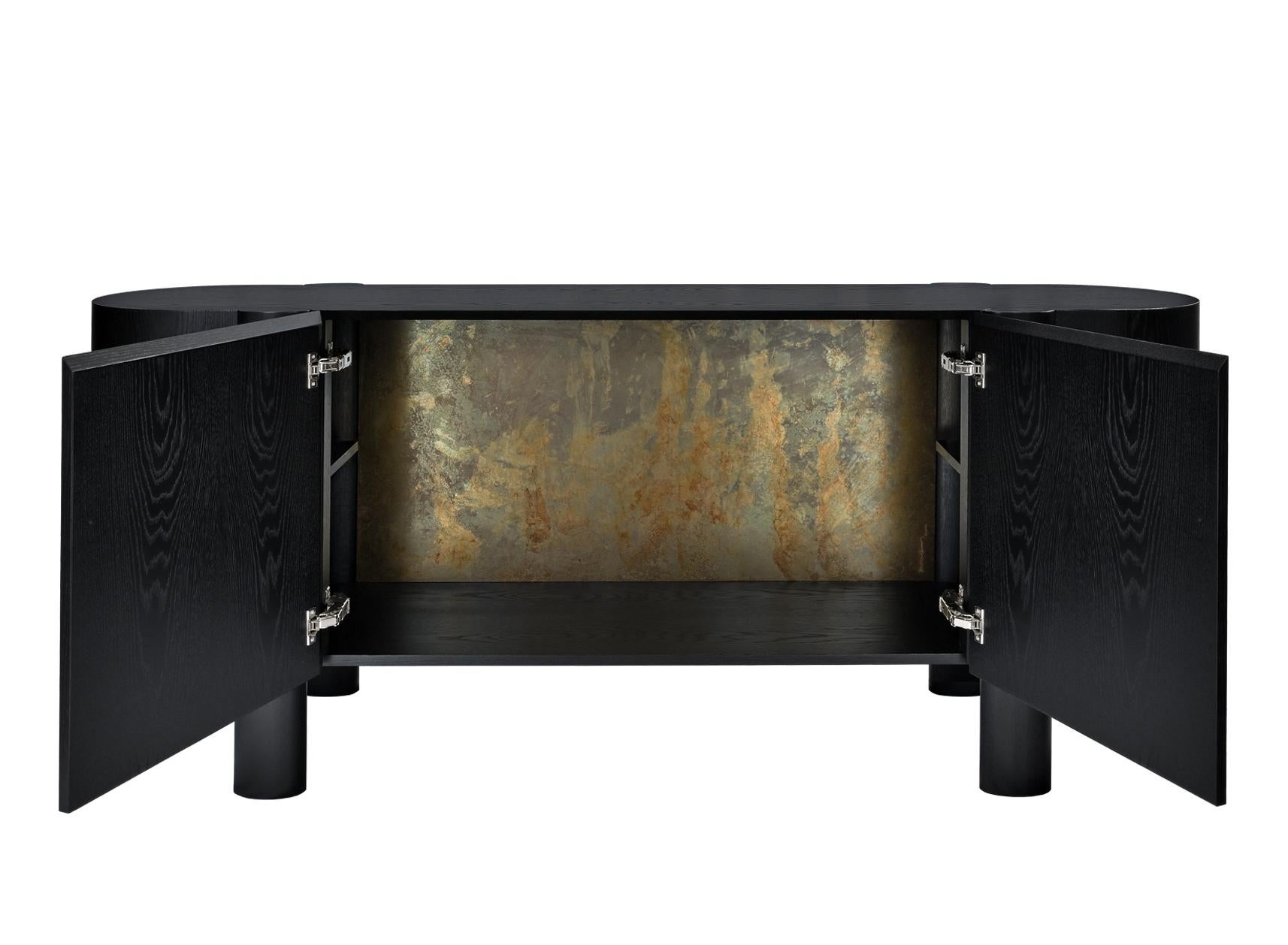 Oak credenza with unique patinated brass interior detailing and hand-carved wood legs and handles.

Brass patina was applied to the Era Credenza by designer to create a special piece for you.
Each patina surfaces are unique, color variations or