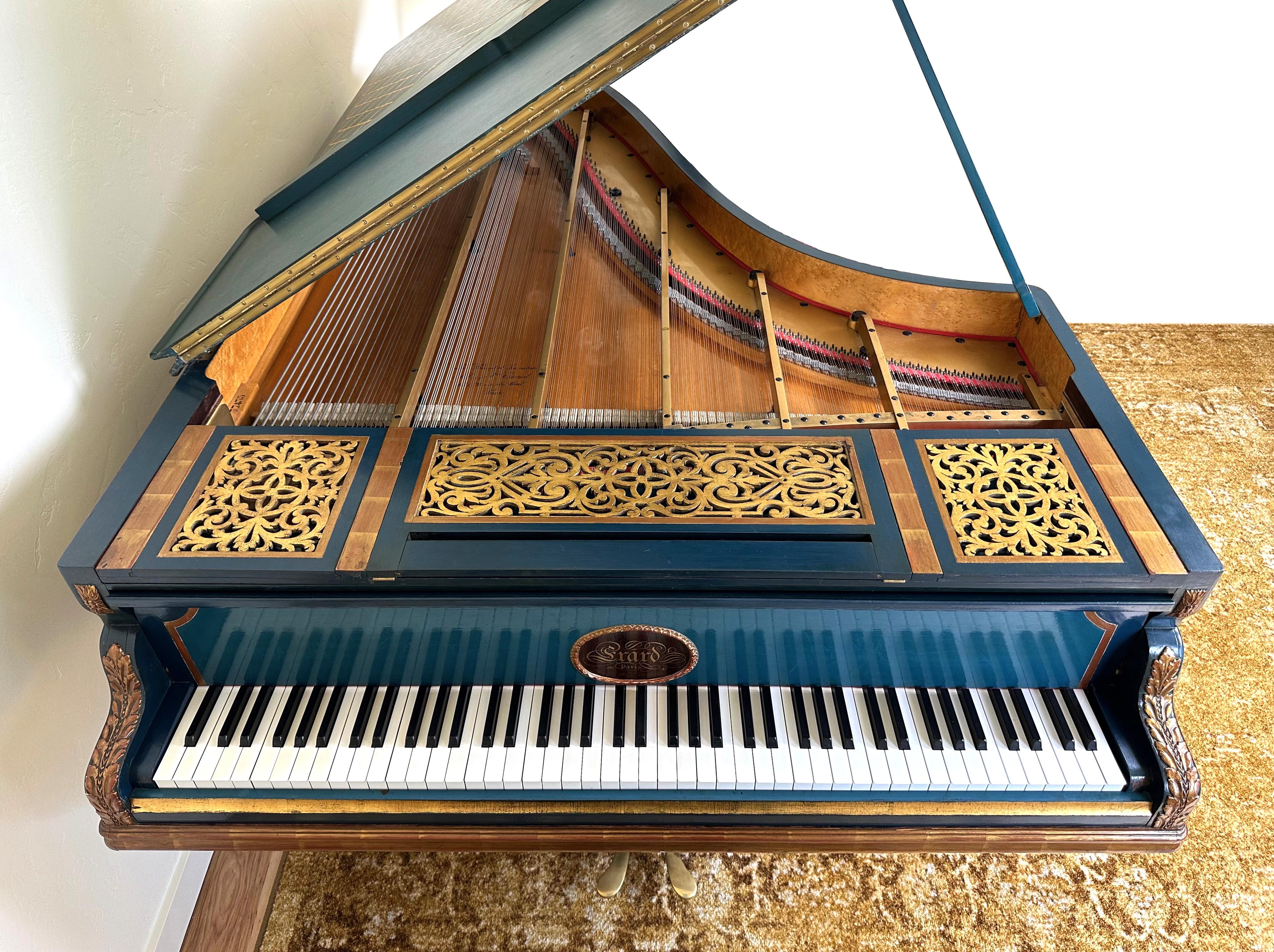 This beautiful grand piano was built by Erard in Paris in 1895.

With irreplaceable original cabinet art created and signed by an artist named Finel - specifically commissioned by the original purchaser - this piano retains original ivory keys, as