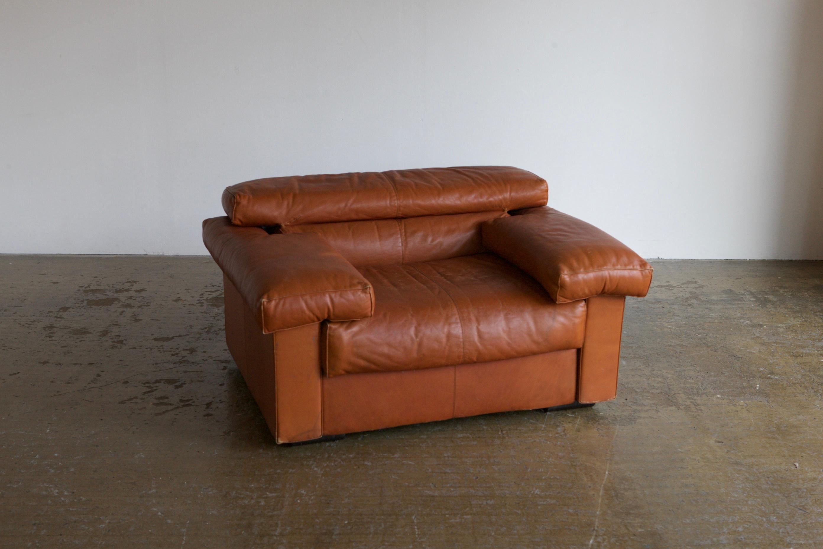 1970's camel leather armchair desiged by the duo Tobia & Afra Scarpa for B&B Italia. This model is deeply comfortable. Good and deep and chic and square. The leather is worn and has had some repairs.
   