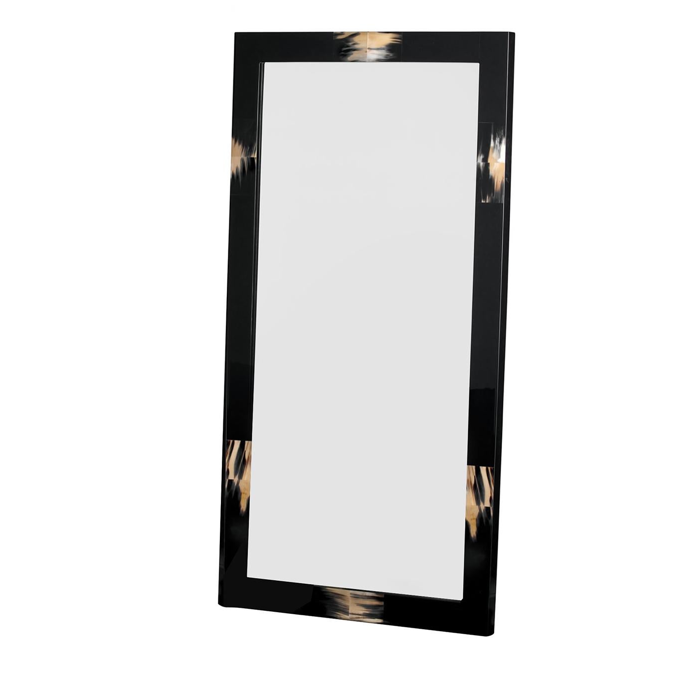 Minimalism meets luxury in this exclusive rectangular wall mirror, piece owing its uniqueness to the presence of precious inlays of authentic dark horn that adorn its bold and clean-lined frame. Fashioned of wood and lacquered in glossy black for a