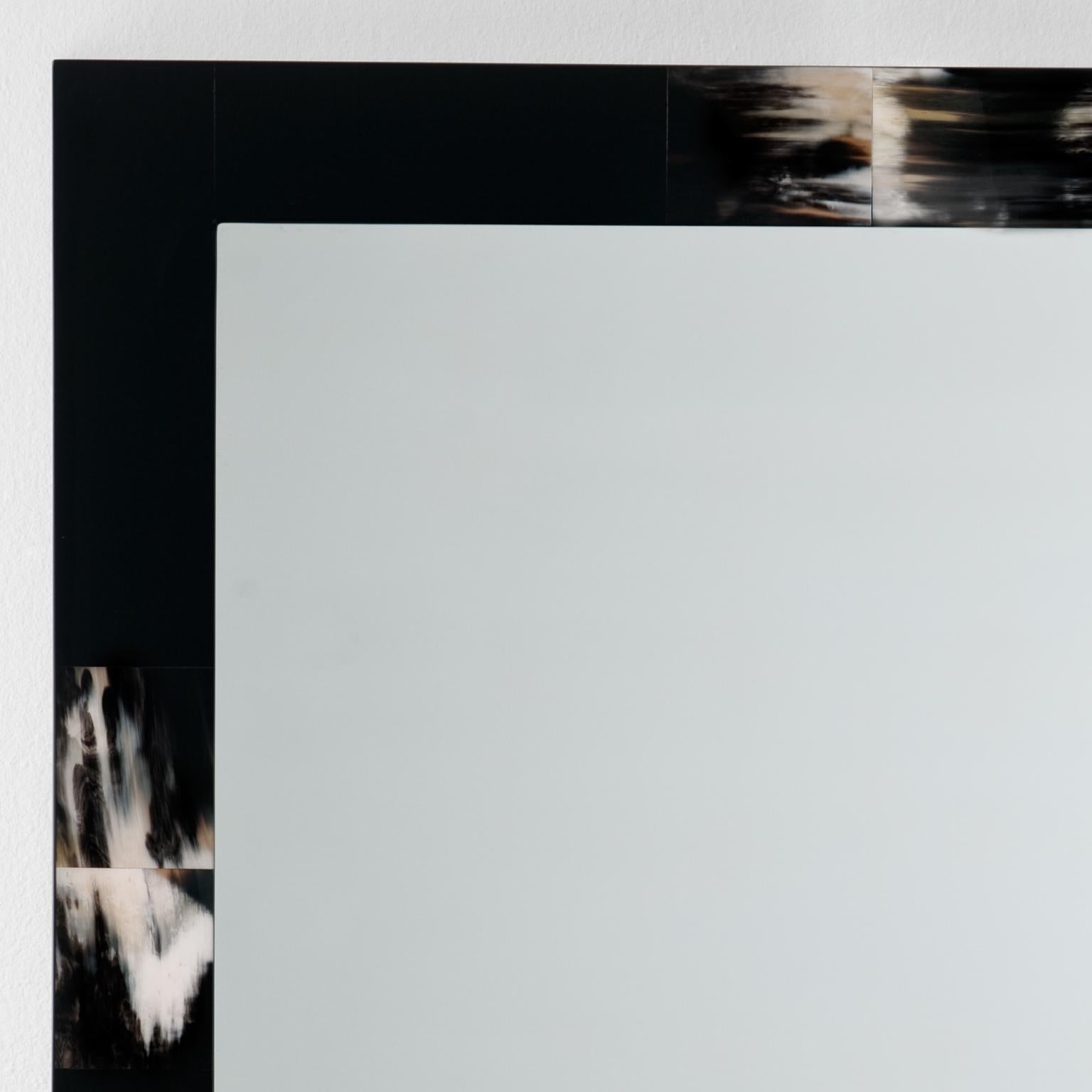 The Erasmo wall mirror achieves its elegance and uniqueness by combining simplicity of design with luxurious craftsmanship and materials. Individually handcut tiles in Corno Italiano are laid in a square wooden structure finished in polished black