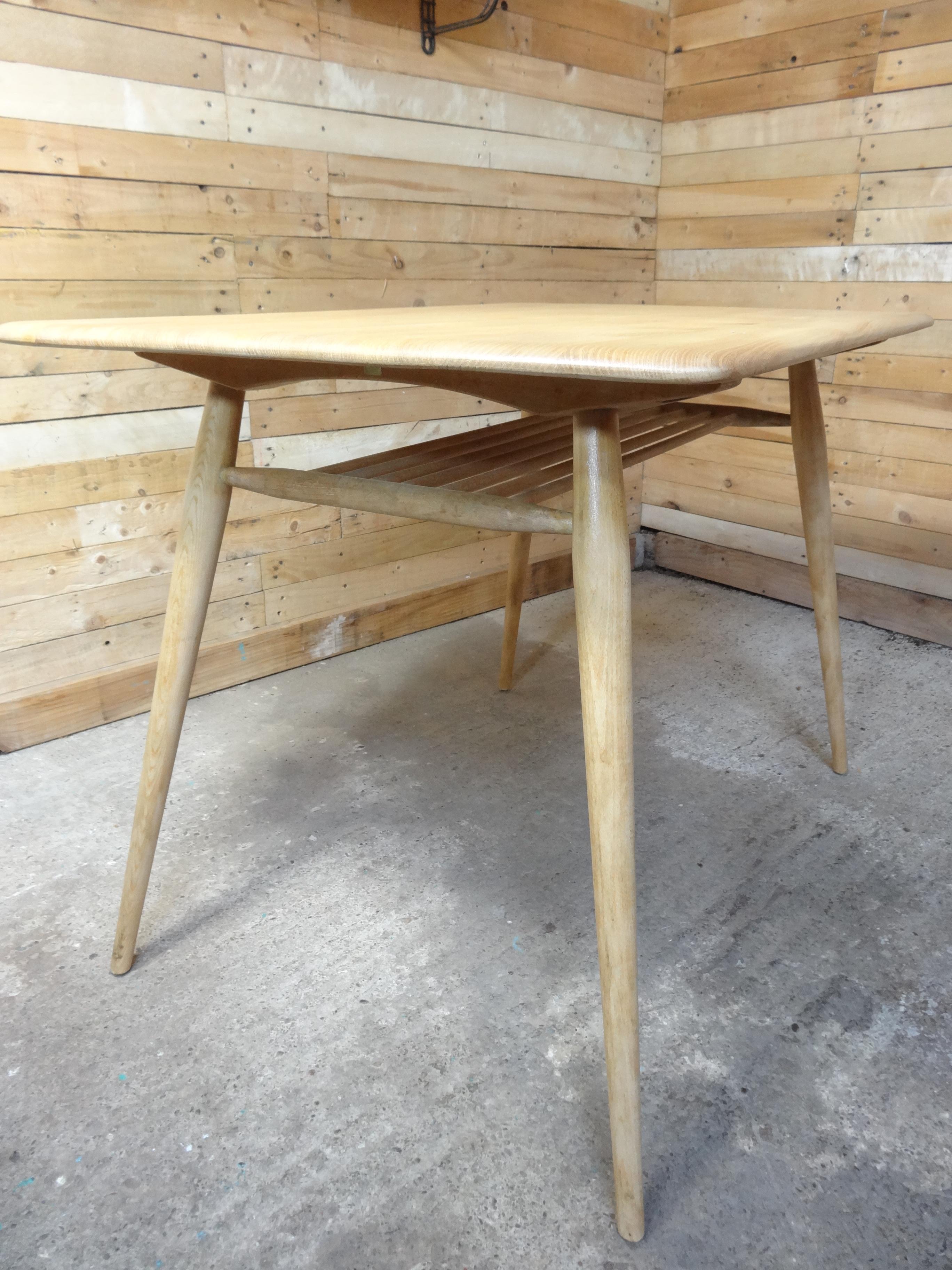 Table designed by Lucian Ercolani for the renowned Ercol furniture makers. We currently have 6 of these tables available, quite a rare table with a very useful magazine rack underneath the table op, great for your coffee shop or