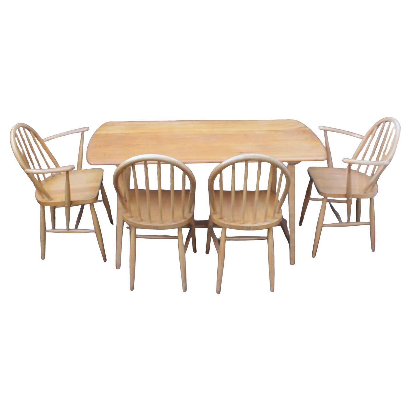 Rare Ercol Dining Table and Chairs – Vintage Mid-Century Modern Charm

Model c41

Circa 1950

The mid-century Ercol Dining Table (Plank Top) and six Ercol hoop-back dining chairs are a stunning combination of craftsmanship, simplicity, and enduring