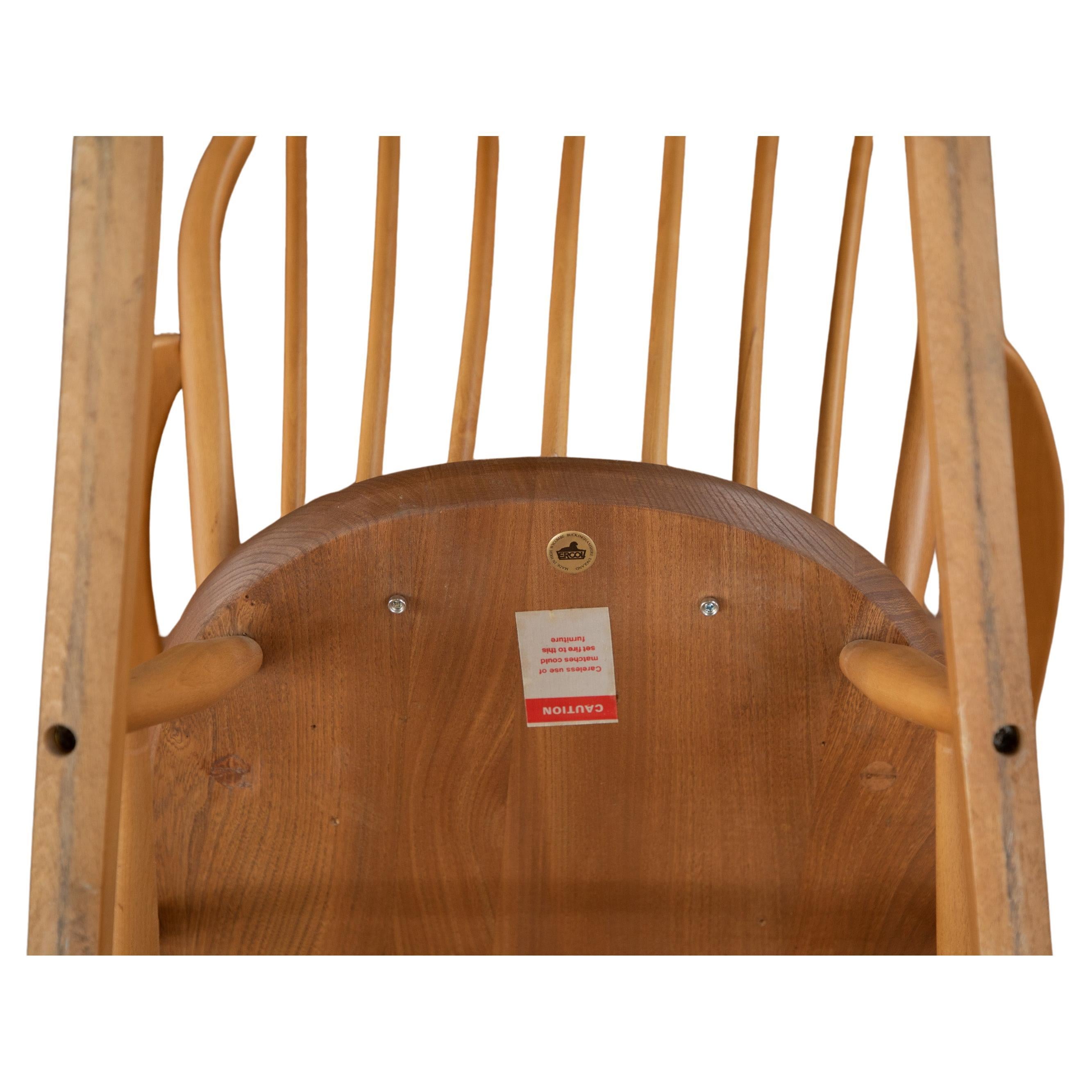 Classic Ercol rocker, low seated nursing chair. 
Ercol No.290/F182 Windsor Utility Range, manufactured circa. 1952

 The chair has a bow, 6 spindle seat-back made from Beech wood. The D shaped chair seat is made from solid English Elm and is