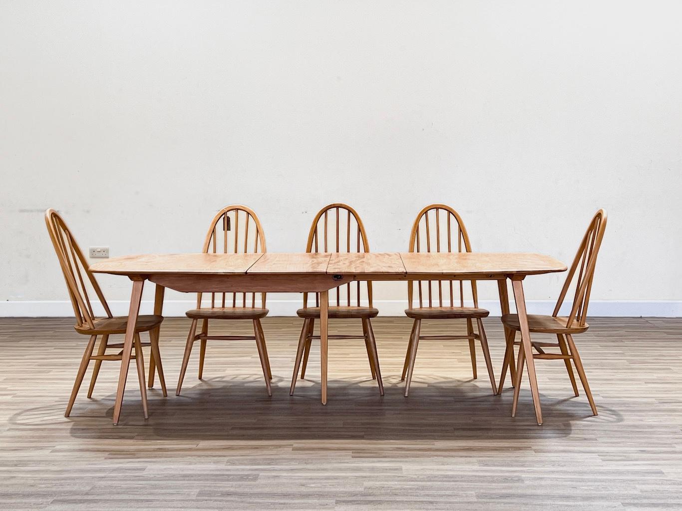 These chairs were designed by Luciano Ercoloni in England during the 1960s. They are part of the Windsor collection, which is renowned for its timeless beauty and expert craftsmanship. The chairs are handcrafted using high-quality Elm wood, which is