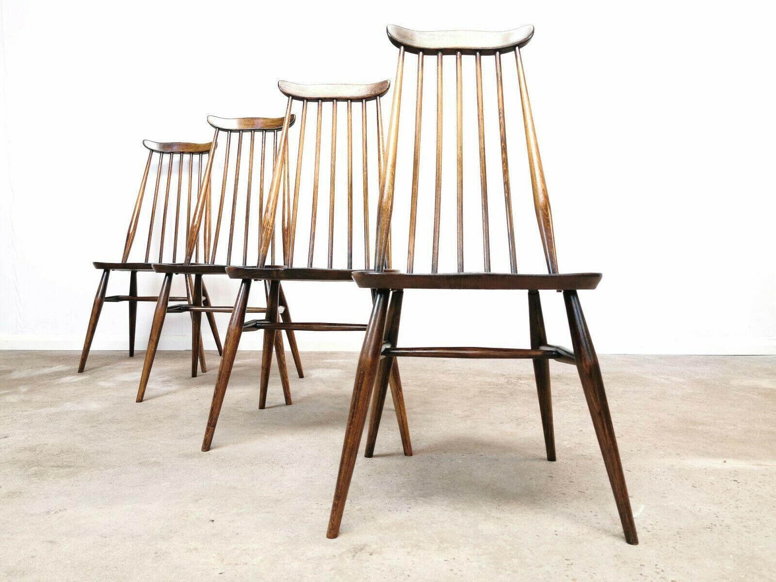 Four Ercol Windsor Goldsmith dining chairs. Superb wood detail and colour.

1960s. Elm and beechwood.
