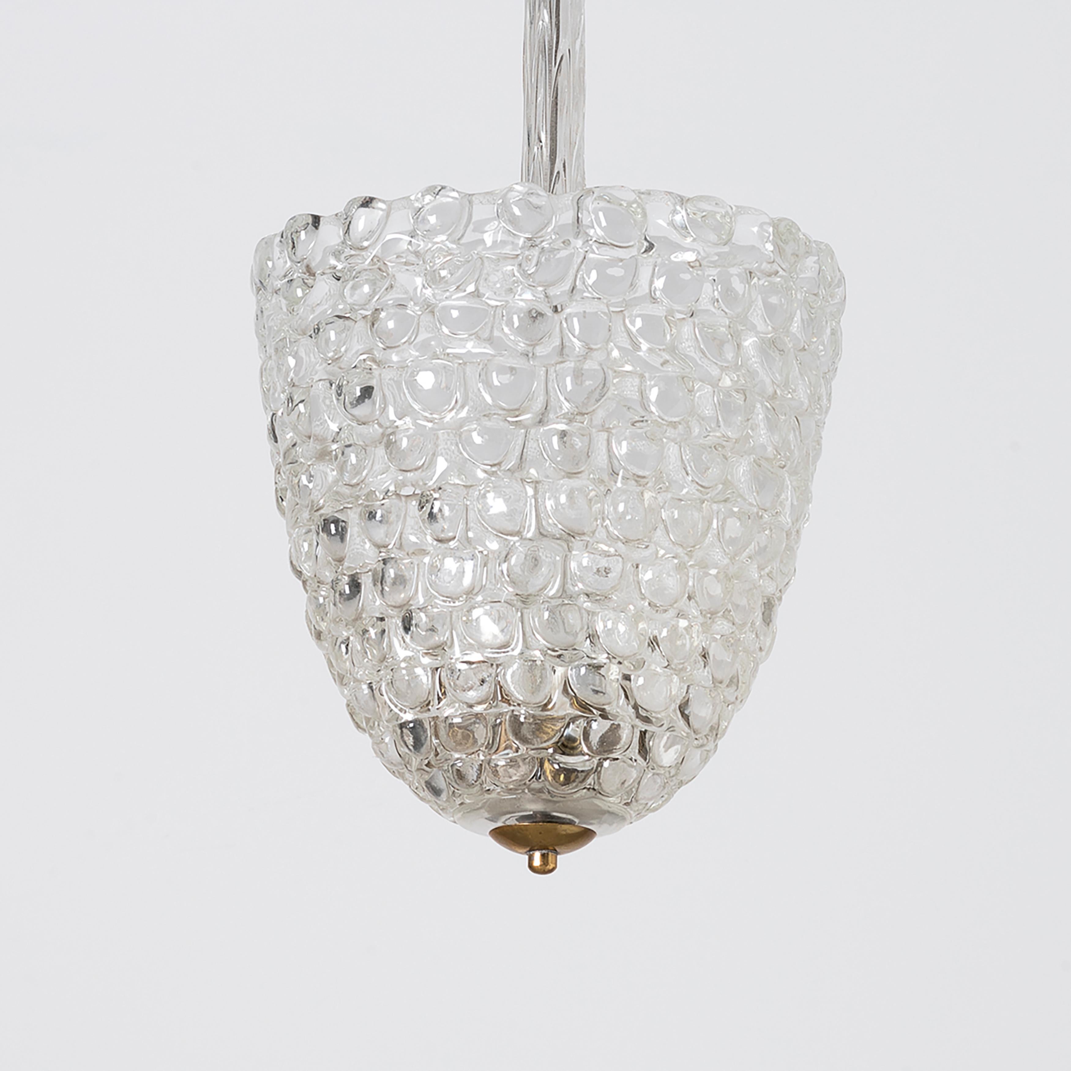 Ercole Barovier elegant and rare clear crystal glass chandelier from Lenti series with semi-spherical applications, glass stem and matching canopy. This crystal glass chandelier with thick fused lentils when lit emits a brilliant patterned