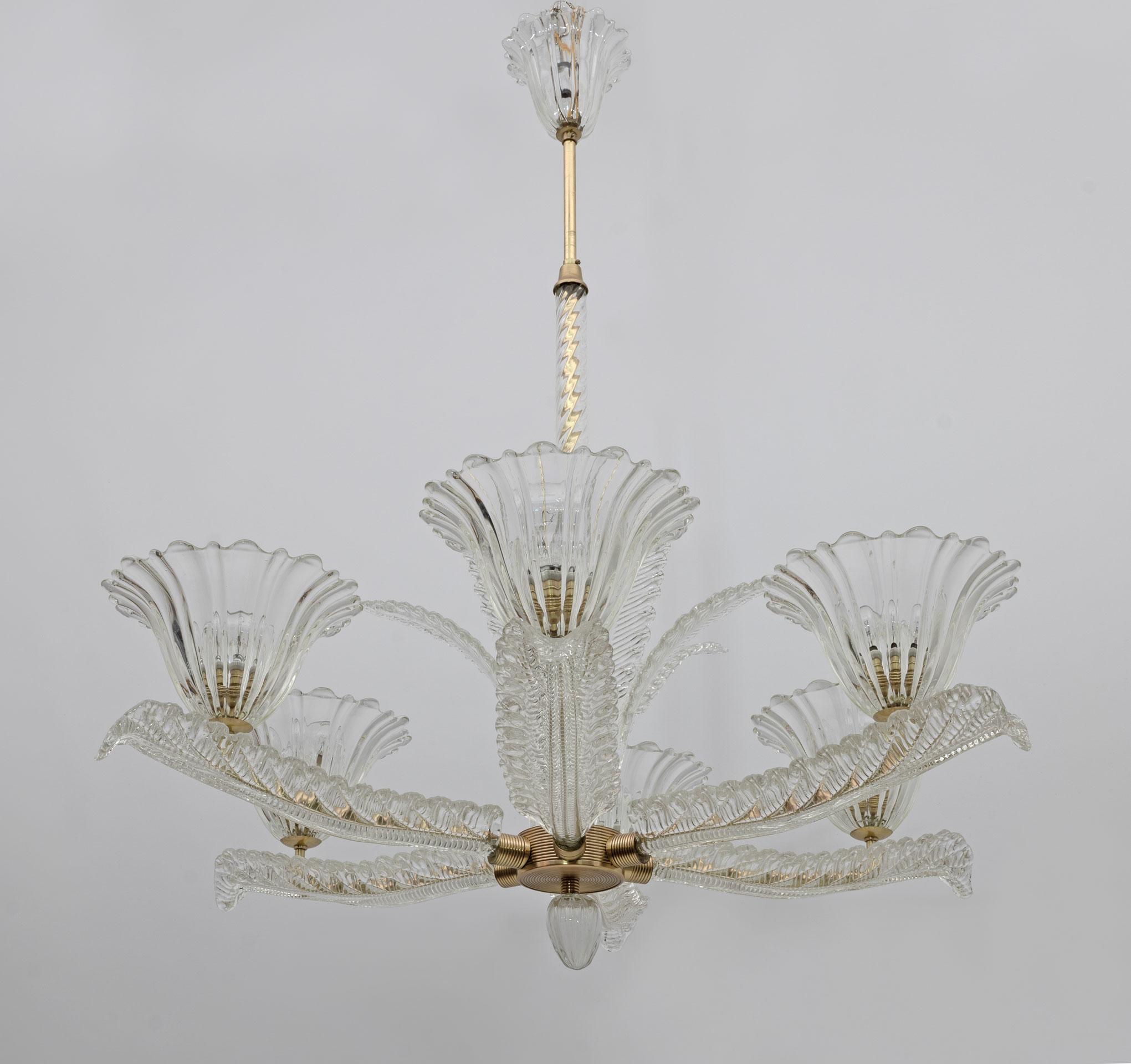 Glass chandelier with six arms in the shape of a tulip and leaf decorations in transparent glass and brass. Designed by Ercole Barovier and produced by Vetreria Artistica Barovier & C in the late 1930s in Italy, this chandelier exudes the spirit and