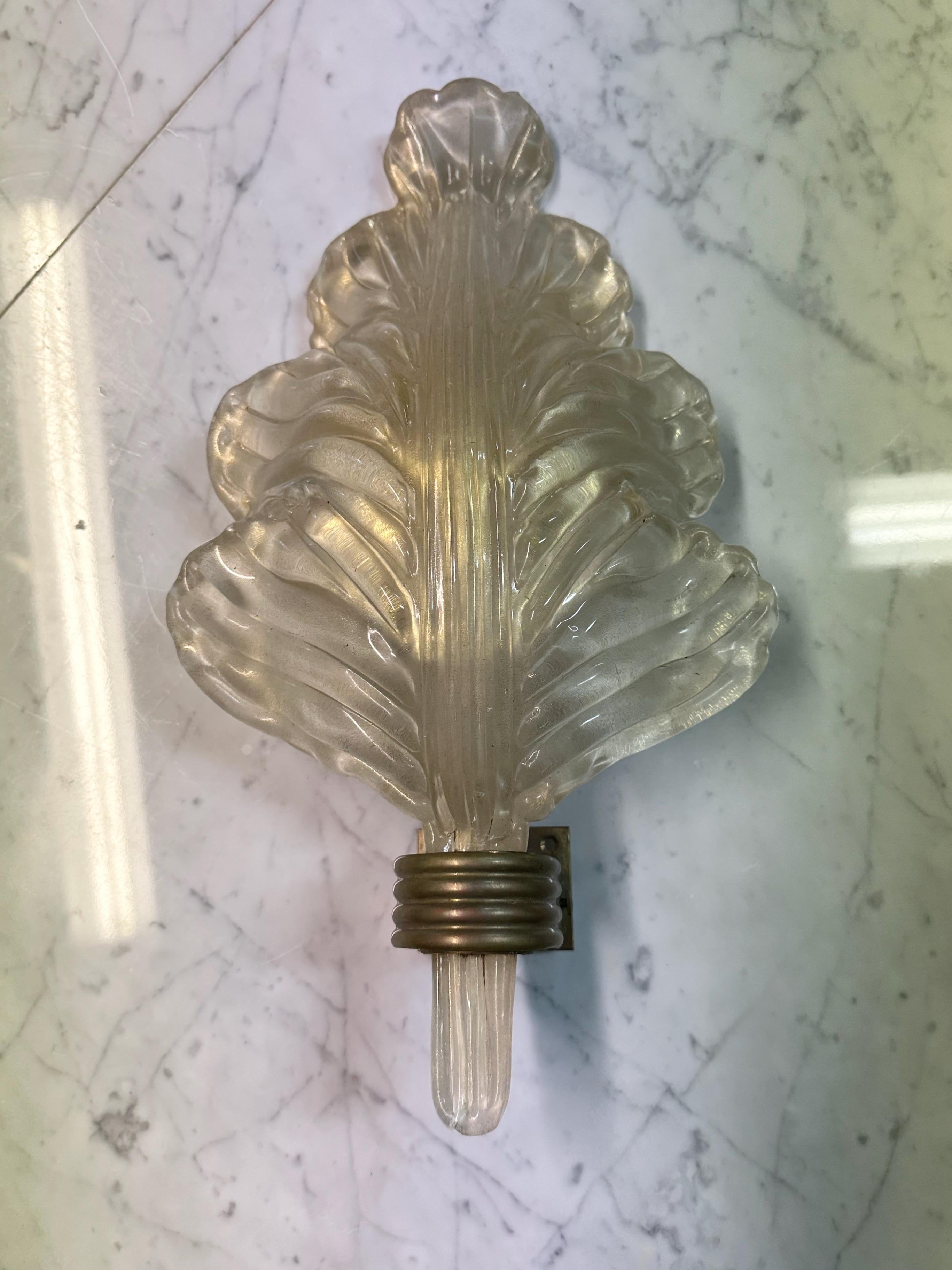 Mid Century sconce by Italian artist Ercole Barovier (1889-1974) for Barovier & Toso. With a glass shade formed into a leaf shape and having a brass backing. The oversized leaf is Murano glass with gold specks throughout. A single candelabra bulb at