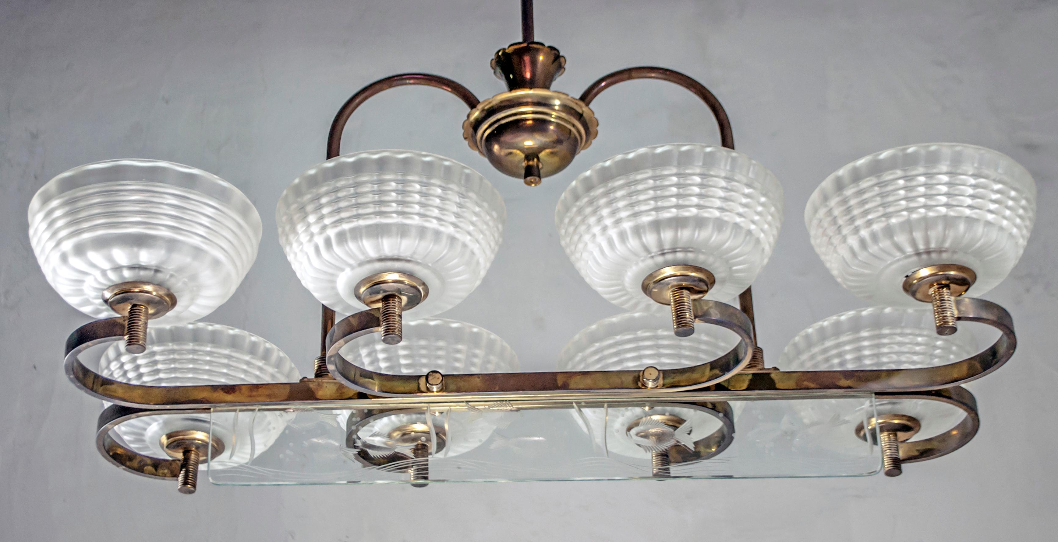 This 8-light chandelier by Barovier and Toso, from the first half of the century, with mouth-blown glass bowls, the structure is in brass, enriched with a beautiful hand-engraved glass representing a seabed, Italy, 1940s.