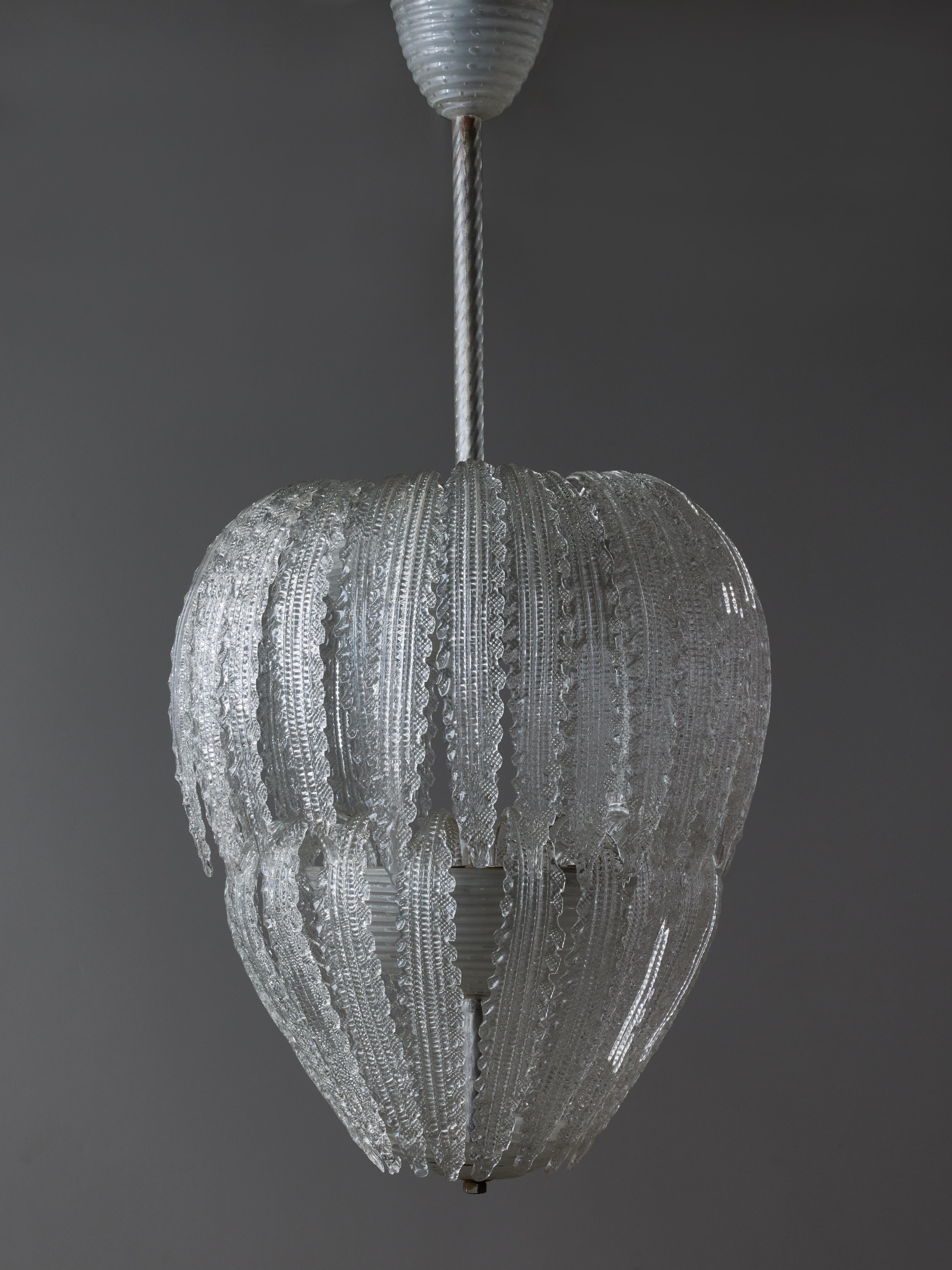 Beautiful example of modern shaped Murano glass chandelier.

This chandelier is made of a central stem with two floors of light, covered with curved leafs, making the chandelier look like a cocoon 