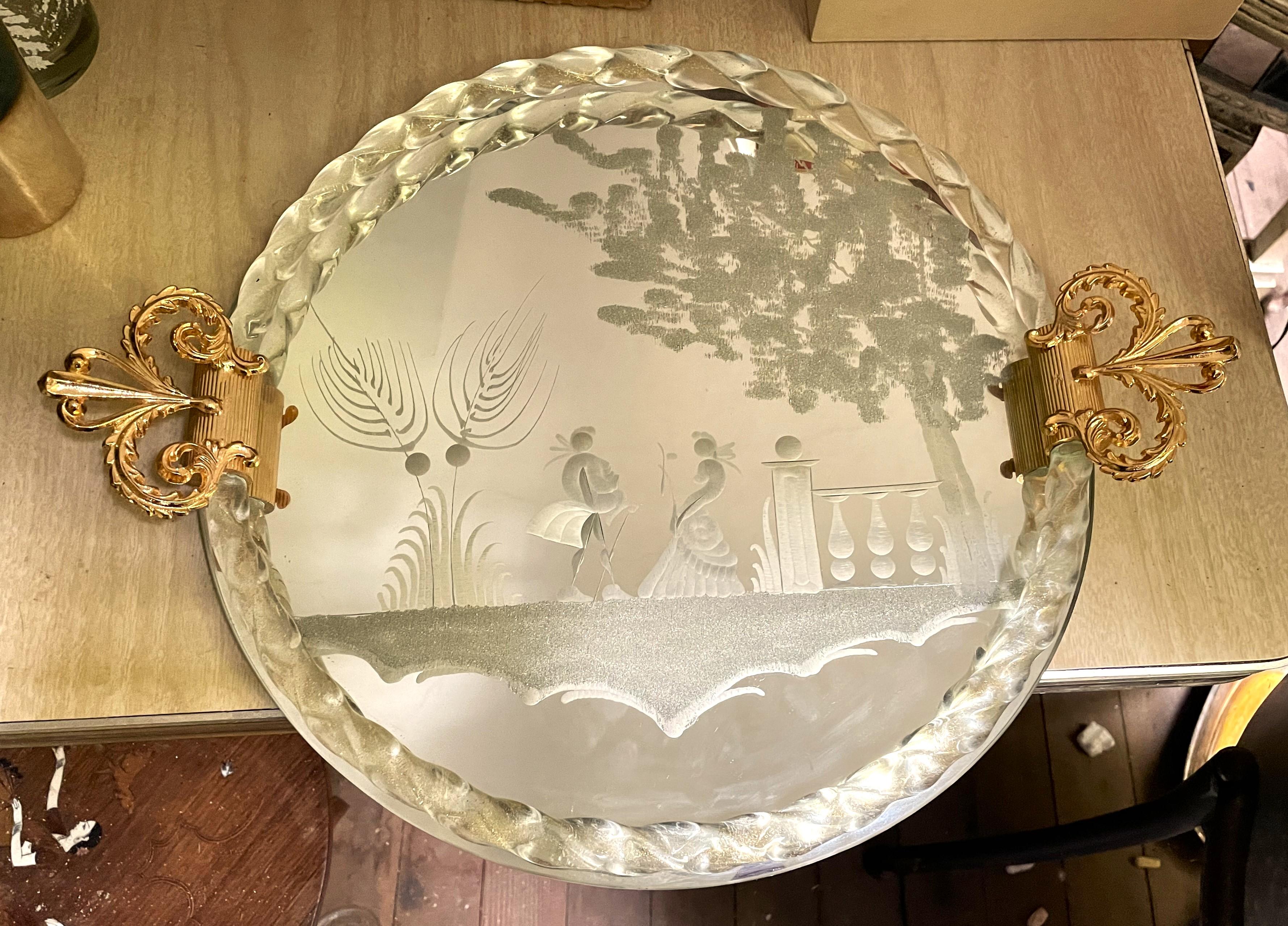 What an absolutely sweet and decorative mirrored tray with a reverse etched romantic Victorian scene of two lovers meeting in a garden, both in full gala appropriate clothing. The scene is surrounded by a border of twisted glass with sparkling gold