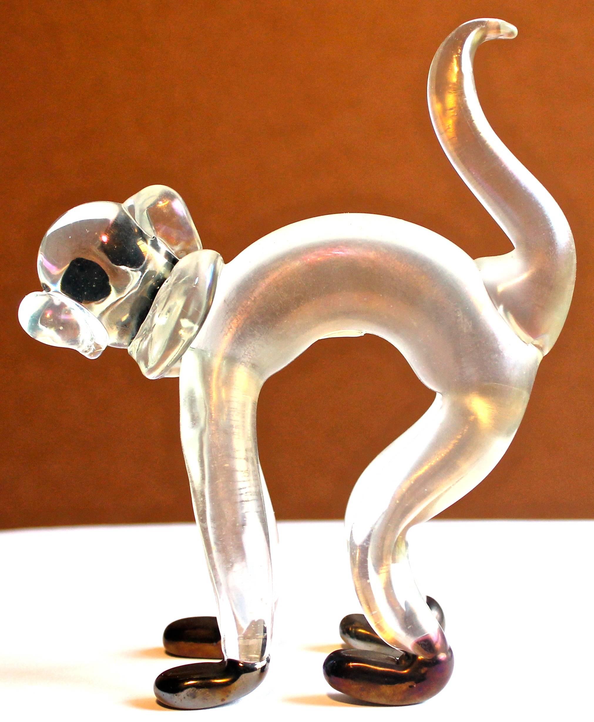 Monkey sculpture of iridized clear and black glass.