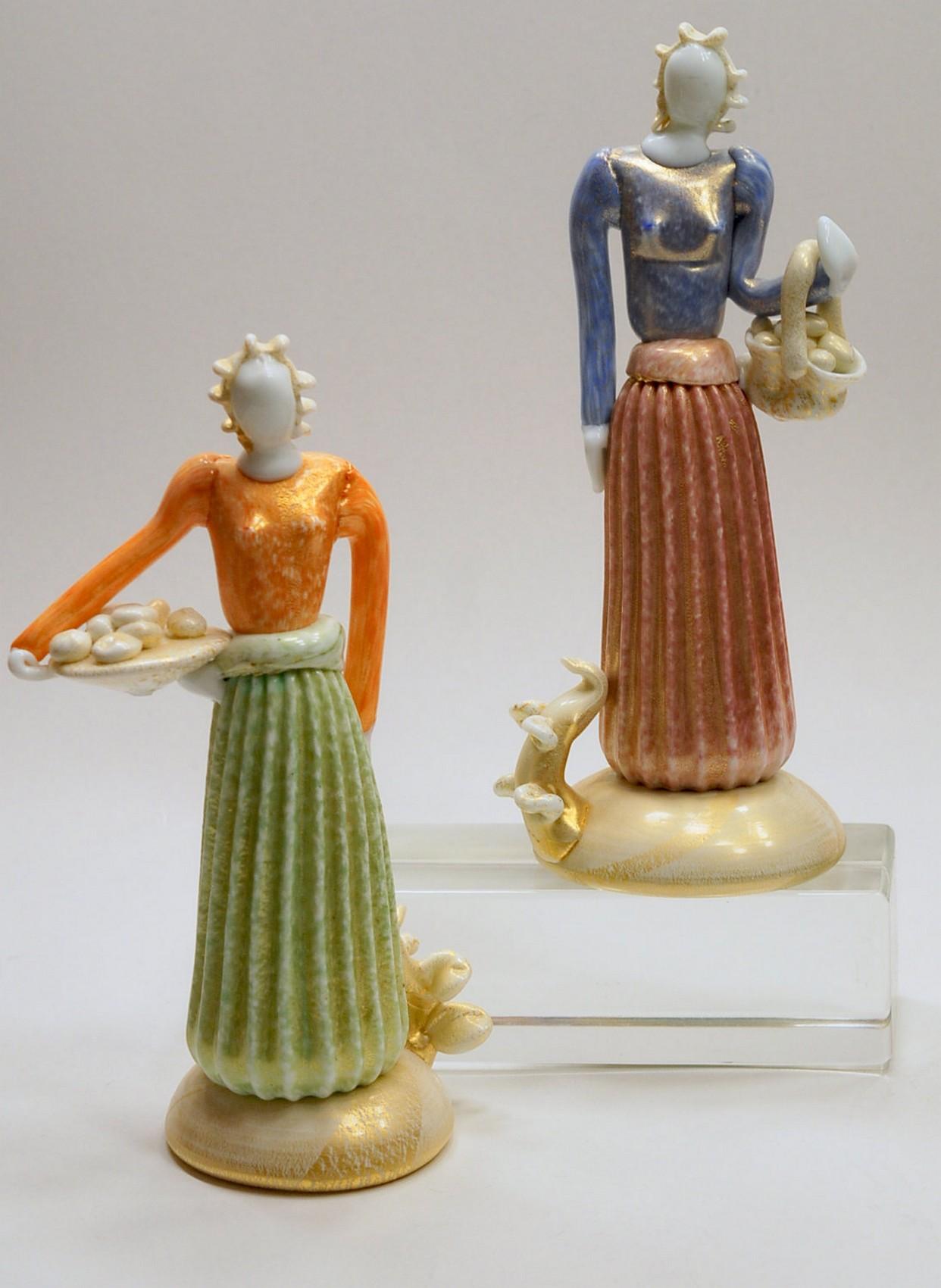 Two well executed Contadine from Ercole Barovier. 

The design of the figure is stylized, probably influenced by De Chirico first metafisica painting. The dress has connection with 