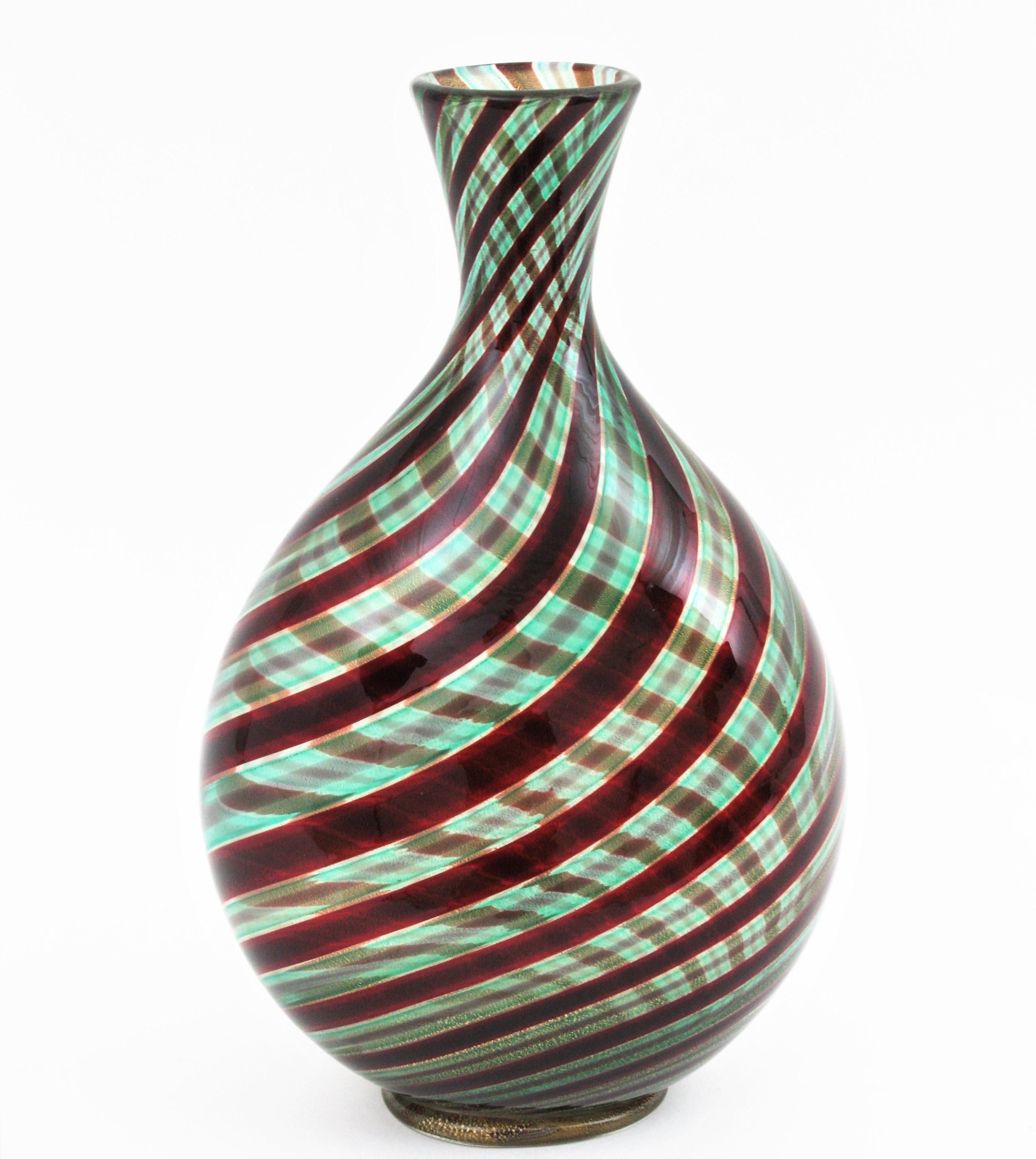 Murano Art Glass 'Spira Aurata Striato Vase' by Ercole Barovier, Barovier e Toso, Italy, 1966.
Spira Aurata series oval-section drop vase in blown green-blue glass with polychrome garnet and golden spiral striped decoration and gold dust. Applied