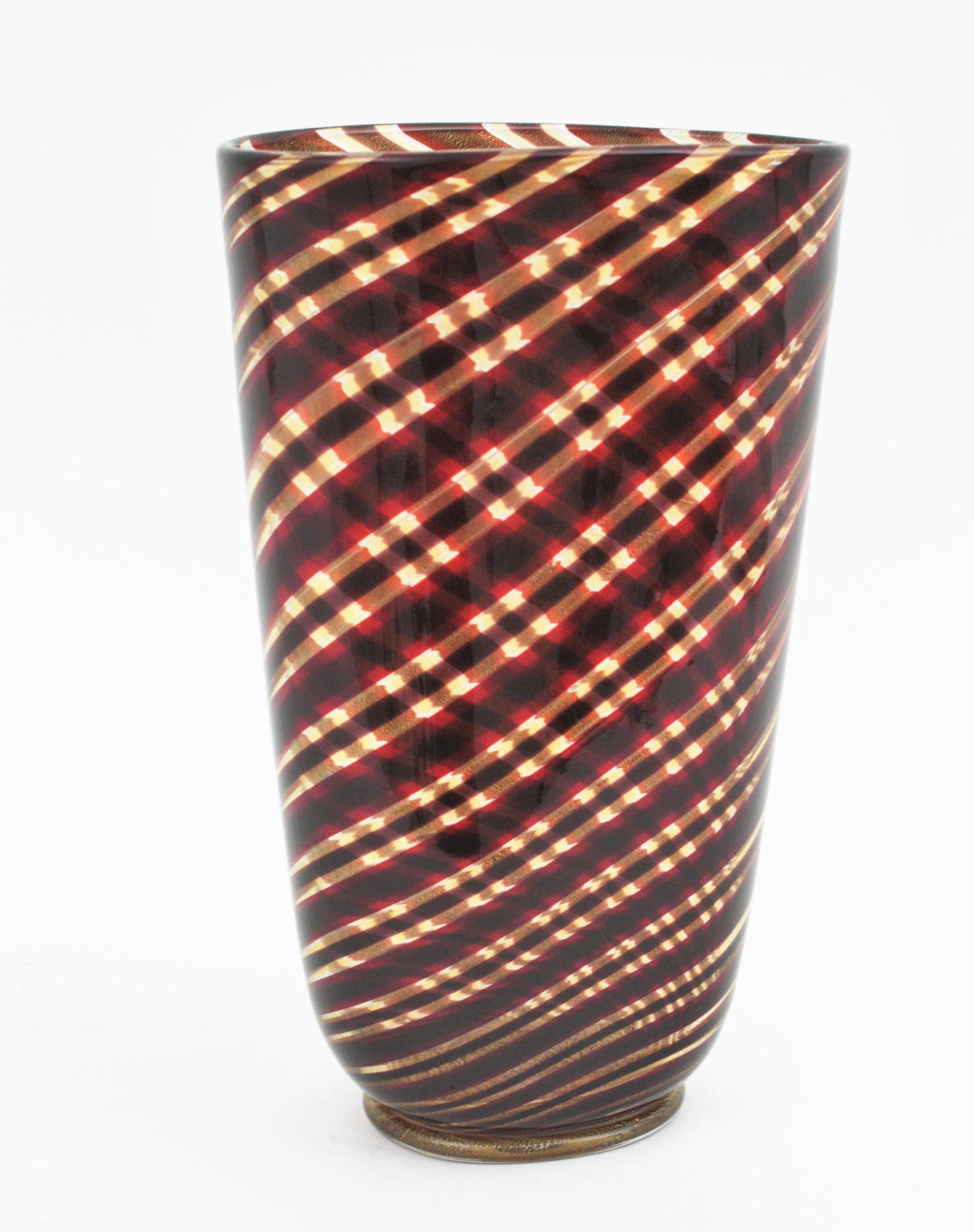 Murano Art Glass 'Spira Aurata Striato Vase' by Ercole Barovier, Barovier e Toso, Italy, 1966.
Spira Aurata series oval-section conical vase in blown glass with polychrome garnet, red and golden spiral striped decoration with gold dust. Applied