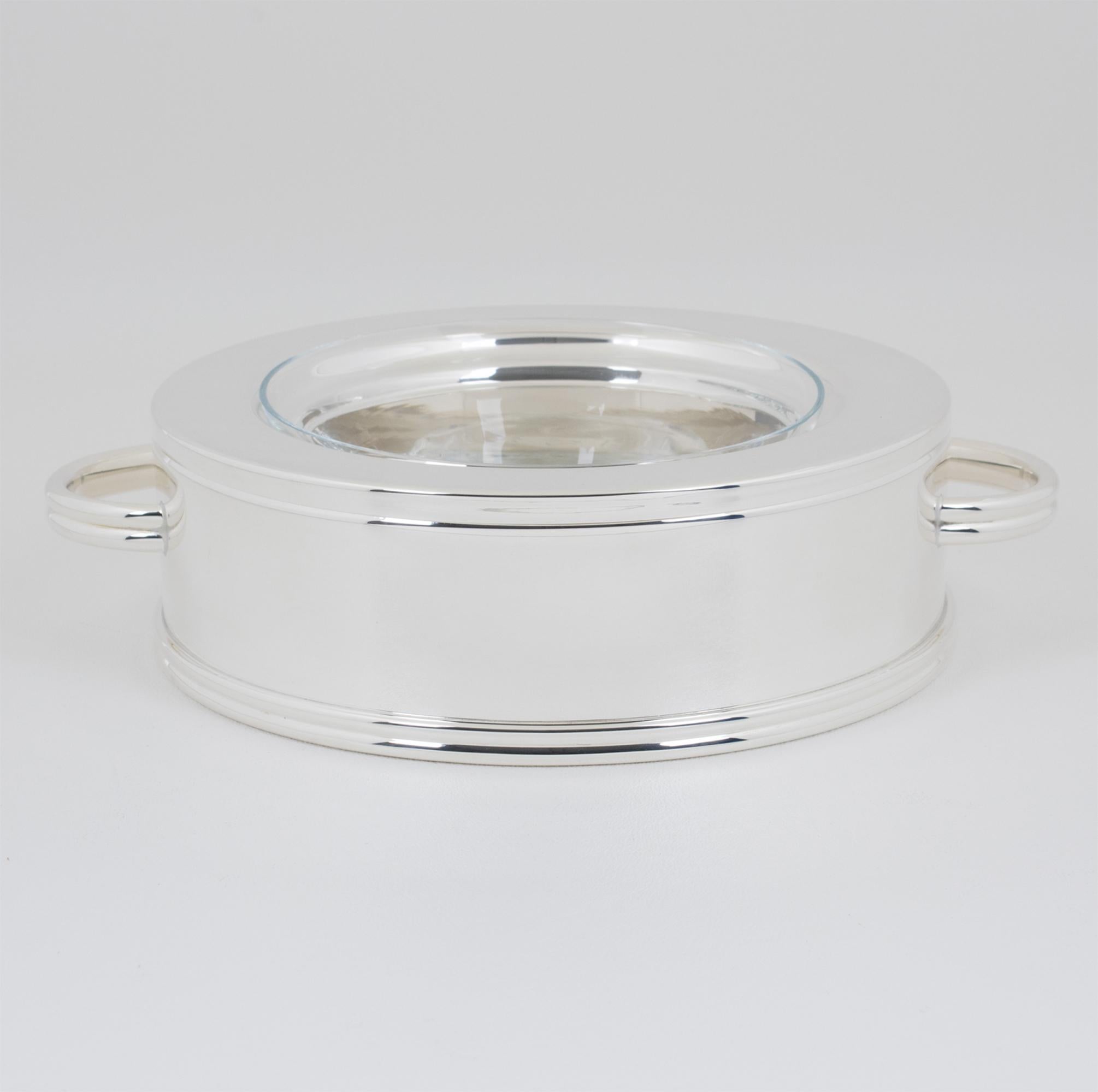French silversmith Ercuis designed this stunning modernist silver plate and crystal caviar serving bowl, dish, or chiller. The serving piece was expertly crafted in France circa 1960. The outstanding design features a streamlined geometric shape, a