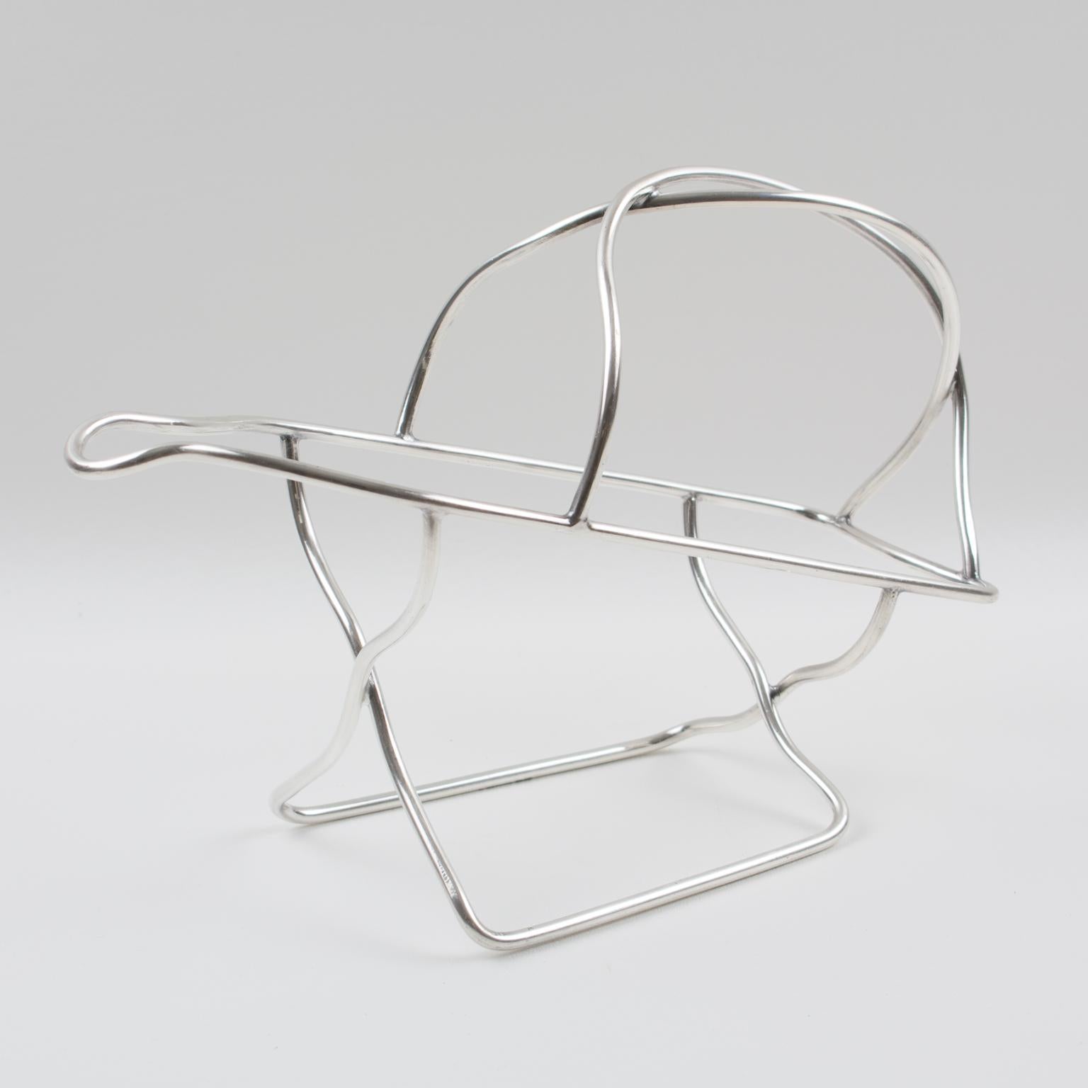 French silversmith Ercuis, Paris, designed this stunning silver plate bottle holder, wine pourer, or server in the 1950s. The piece features a streamlined shape with a minimalist design. The legal silversmith hallmarks are engraved on the
