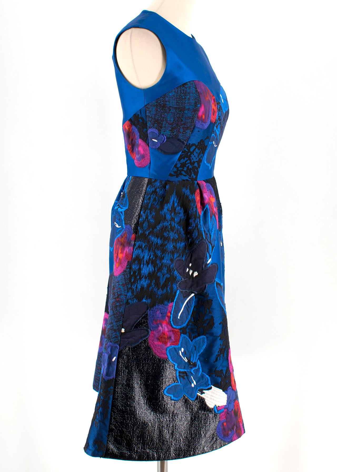 Erdem Floral Embroidered Blue Jacquard Dress

- blue jacquard dress
- midi length 
- floral motives
- black lace embellishment
- round neckline
- sleeveless
- silk lining 
- zip and hoop closure to the back 

Please note, these items are pre-owned