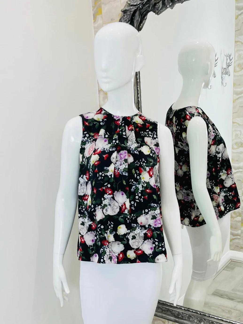 Erdem Floral Top

Black with multi-coloured flowers throughout. Sleeveless with dart. pleating to the front and key hole closure.

Additional information:
Size – S (Label missing but corresponds)
Composition- Label Missing - Feels Like Silk