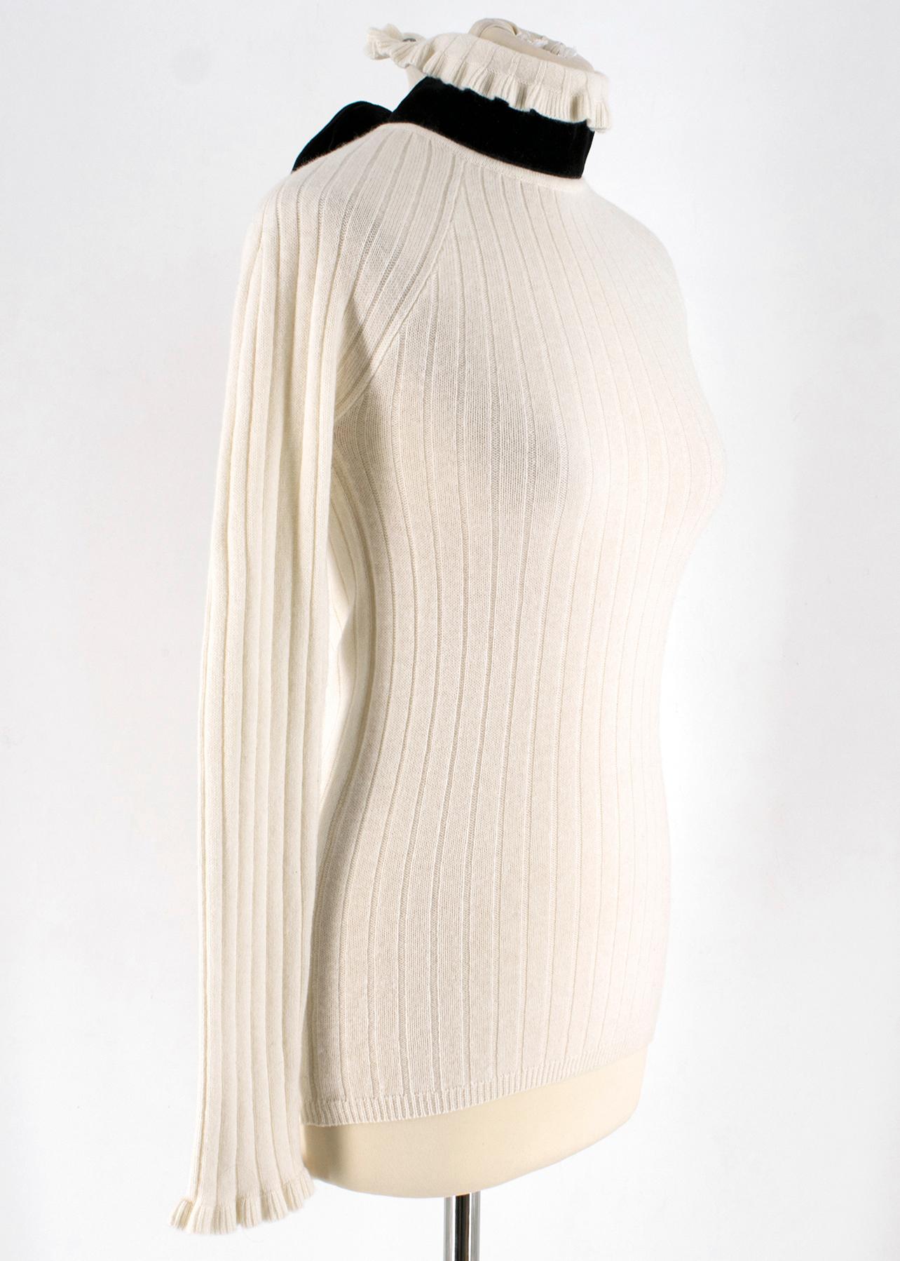 Erdem White Wool blend Open Back Sweater

- white wool blend sweater 
- high neck
- open back line
- button fastening to the neck
- black velvet ribbons around neckline
- long sleeve

Please note, these items are pre-owned and may show some signs of