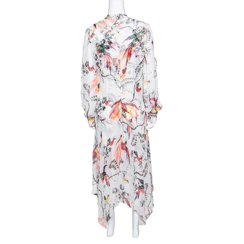 Erdem brings you this beautiful dress that was launched as a part of their 2017 collection. The dress is made from silk and designed with prints of parrots and leaves, long sleeves and an asymmetric hem. Pastel sandals or beige ones will perfectly