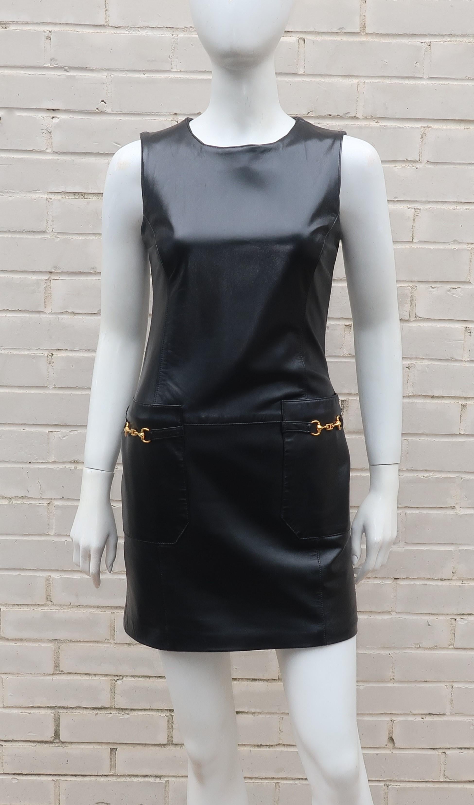 Erez Levy black leather mini dress with gold tone horsebit details, made expressly for Saks Fifth Avenue.  The jumper style silhouette zips at the back with full lining and front pockets.  A fun look that could be worn on its own or with a skinny