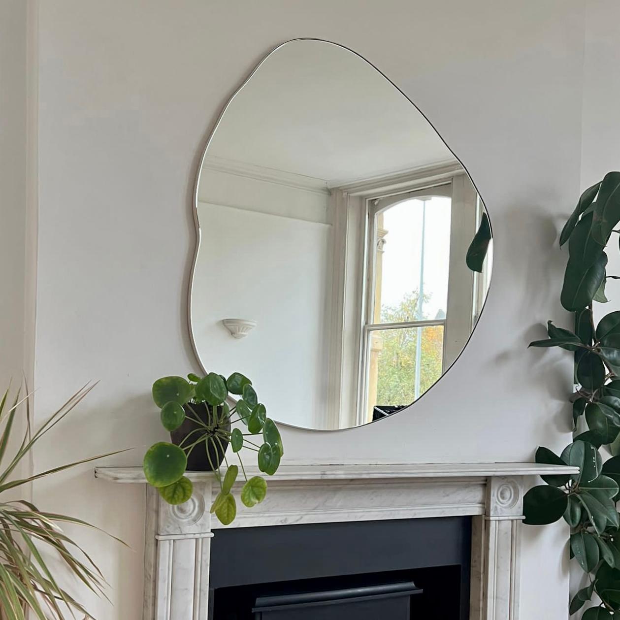 Playful and modern Ergon™ organic shaped mirror with a solid brushed brass frame. Designed and made in London, UK.

Our mirrors are designed with an integrated French cleat (split batten) system that ensures the mirror is securely mounted flush with