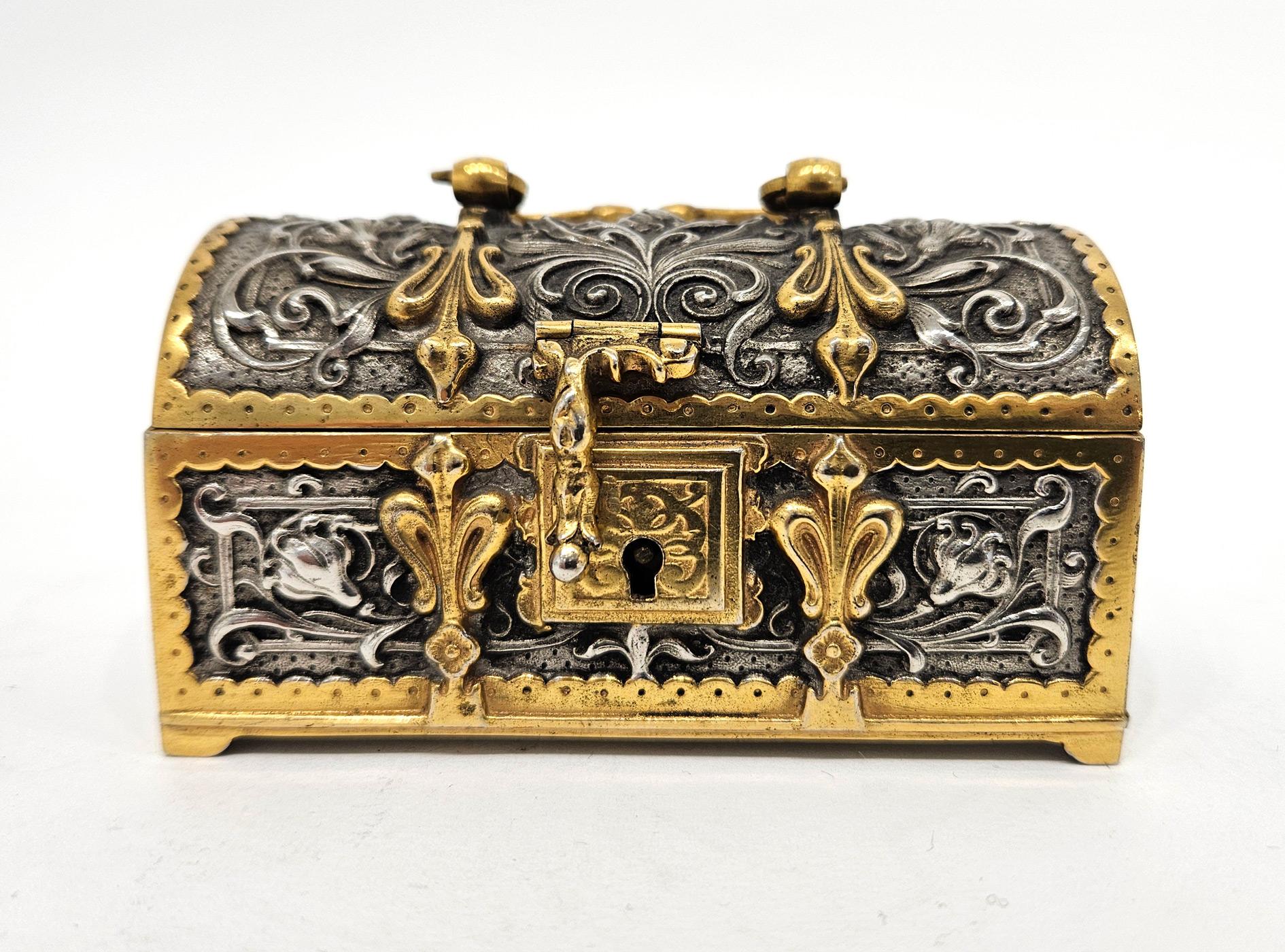 A beautiful art nouveau casket made by Erhard and Sohne in Germany in c. 1905. 

The casket is exquisitely executed with foliate detailing, made in the Gothic revival style in both polished and silvered brass and with a handle to the lid. It bears