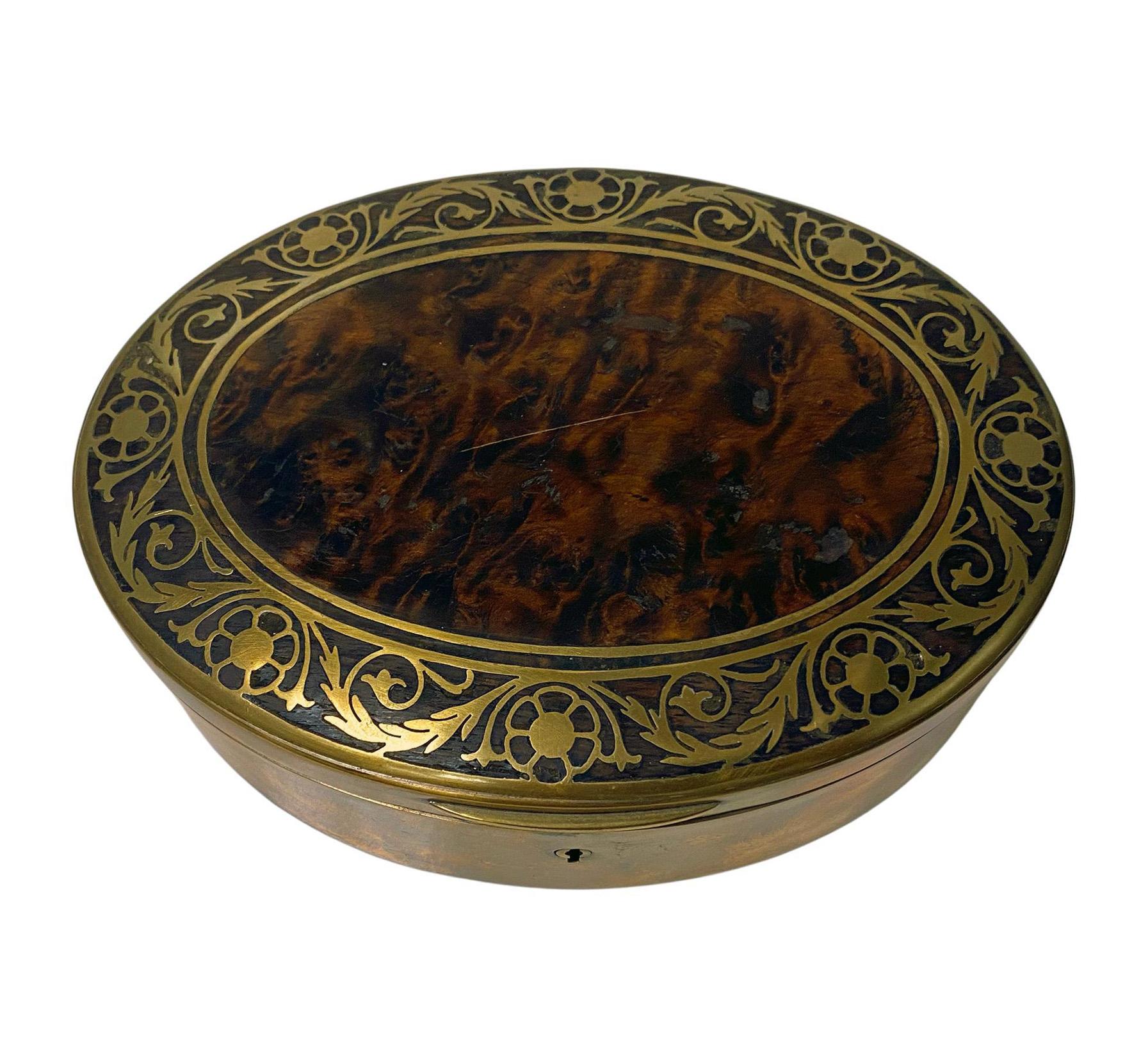 Erhard & Sohne burlwood covered Jewellery box, Germany C.1900. The oval box with brass inlay intarsia design work, original velvet lining. Good tight fit, brass inlay in very good condition, light minimal surface wear to burl, commensurate with age,
