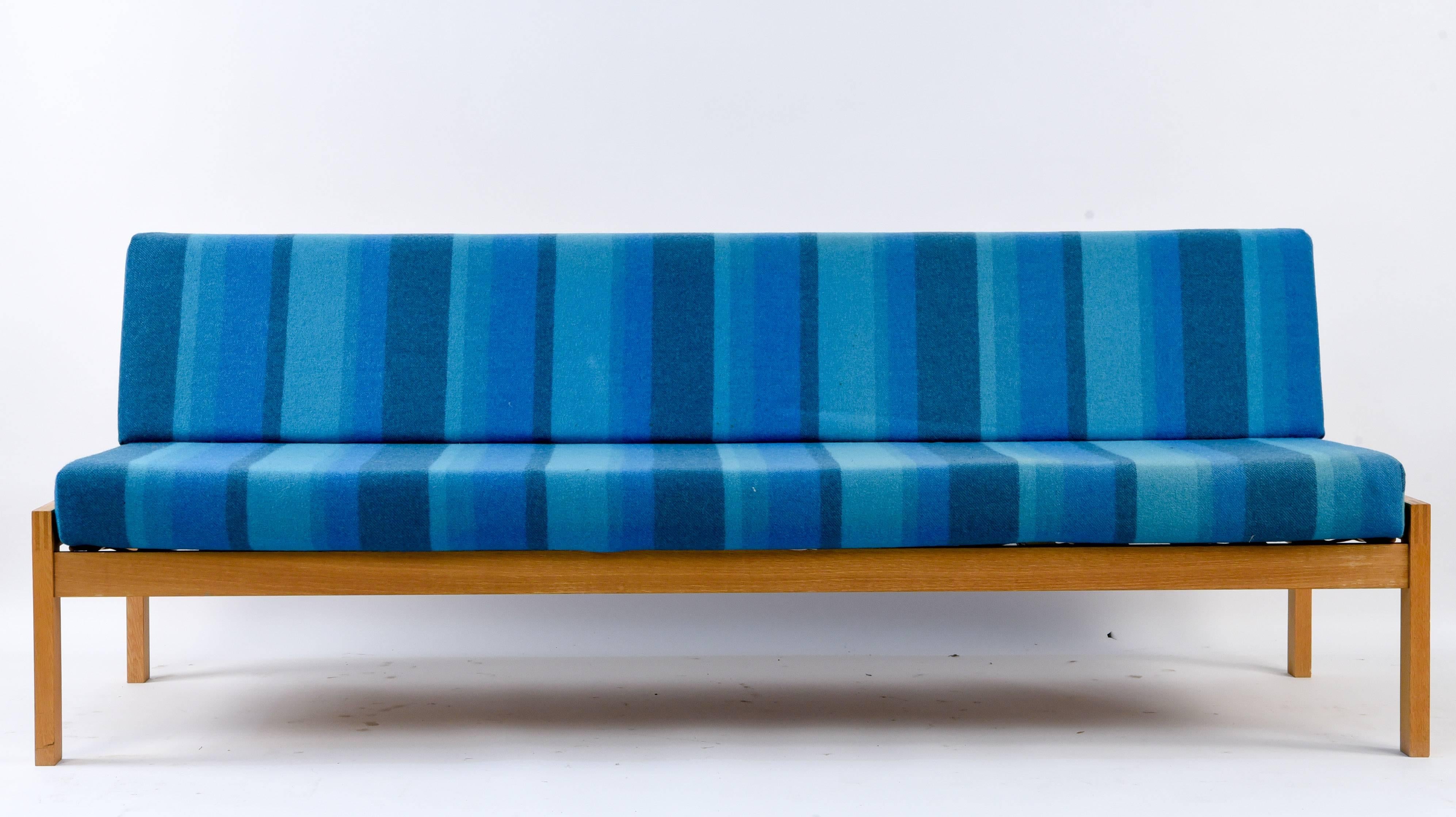 This daybed dates from 1969 and features a frame of oakwood with striped blue upholstery. Made by Erhardsen & Andsersen, sometimes stylized as ERAN. The simplistic lines of this form make it a versatile Minimalist piece.