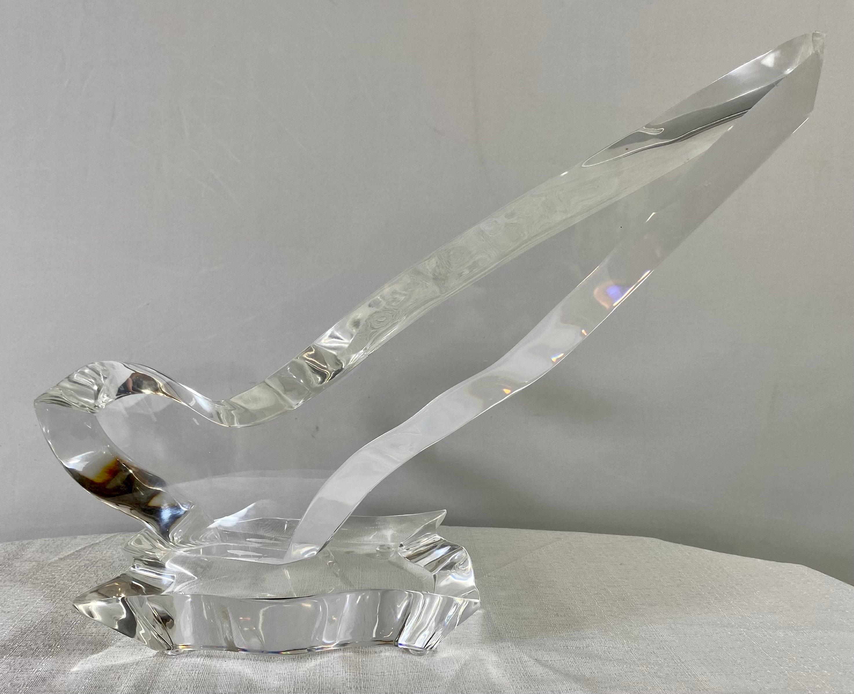 A modersnist abstract lucite sculpture by Eric Bauer ( American, 1963). The sculpture in a shape of a bird is raised by a lucite base and it is signed by the artist Eric Bauer and numbered 93/350.  The sculpture is modern and elegant and will add