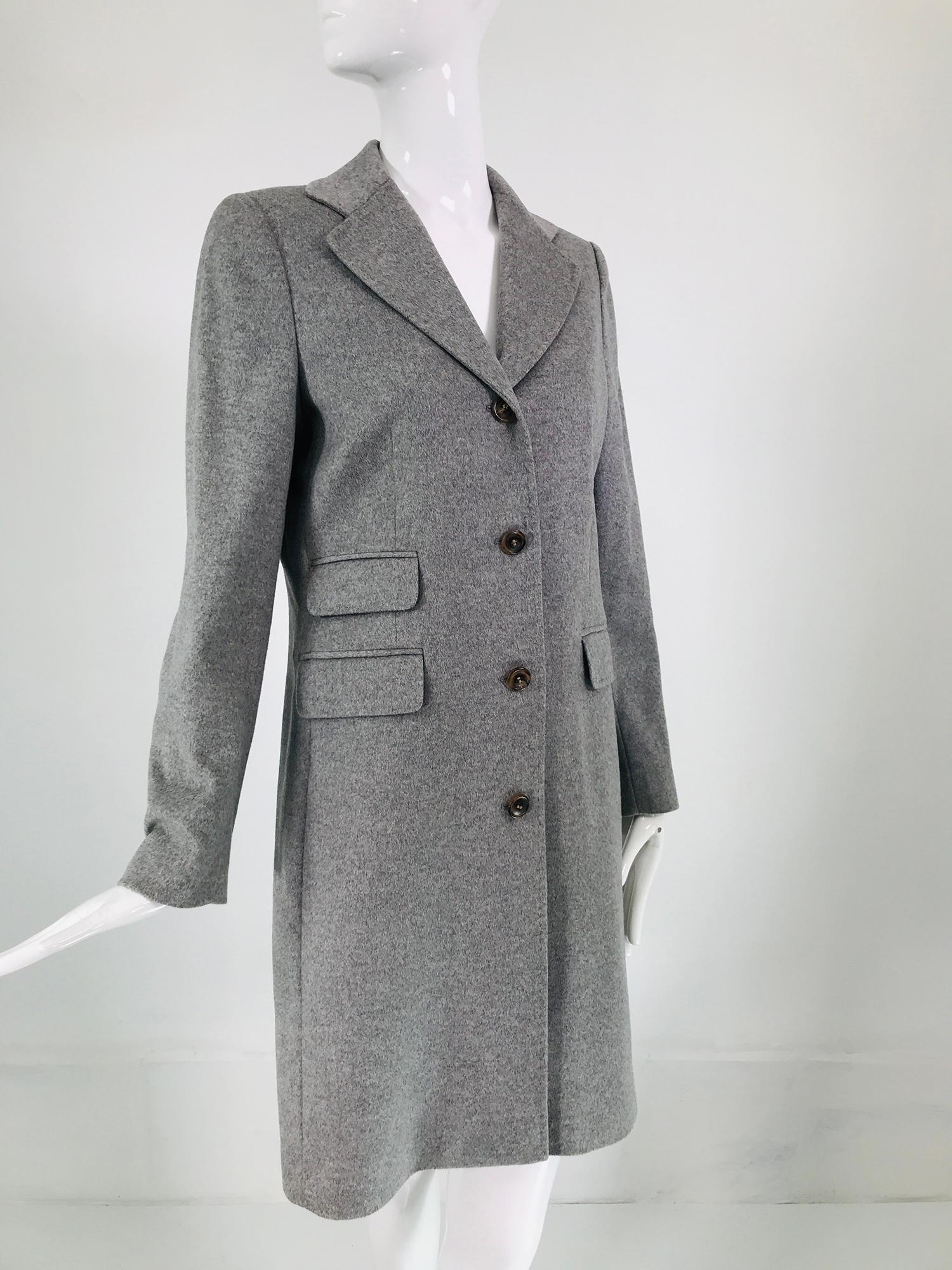 Eric Bompard pale grey cashmere single breasted coat. Classic man tailored coat with great details. Notched lapel collar, top stitching on facings, besom flap pockets, 2 on the right and 1 on the left. The long sleeves have button cuffs. The back