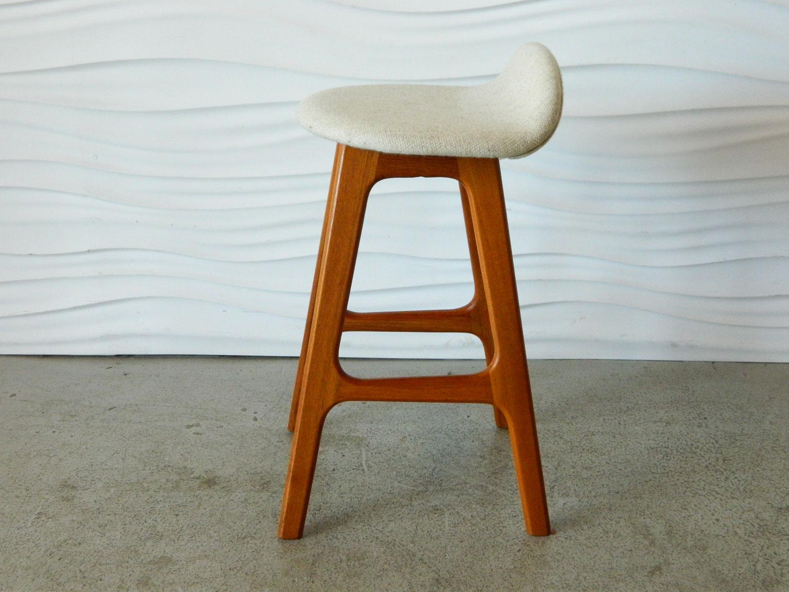 Classic Erik Buck teak stool with original oatmeal-colored upholstery. Please note that this stool is lower than typical bar or counter height stools.