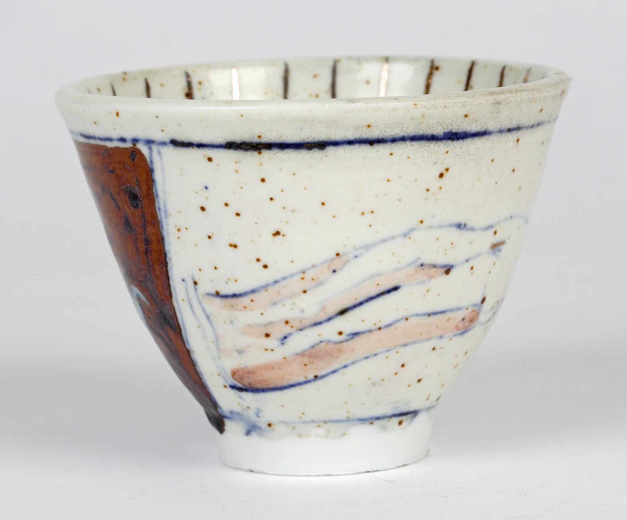 A unique hand painted British studio pottery bowl decorated with a nude by Eric James Mellon and dated 2002. The porcelain bowl stands on a narrow rounded foot and is decorated in ash glazes and hand painted with a stylised nude lying outstretched