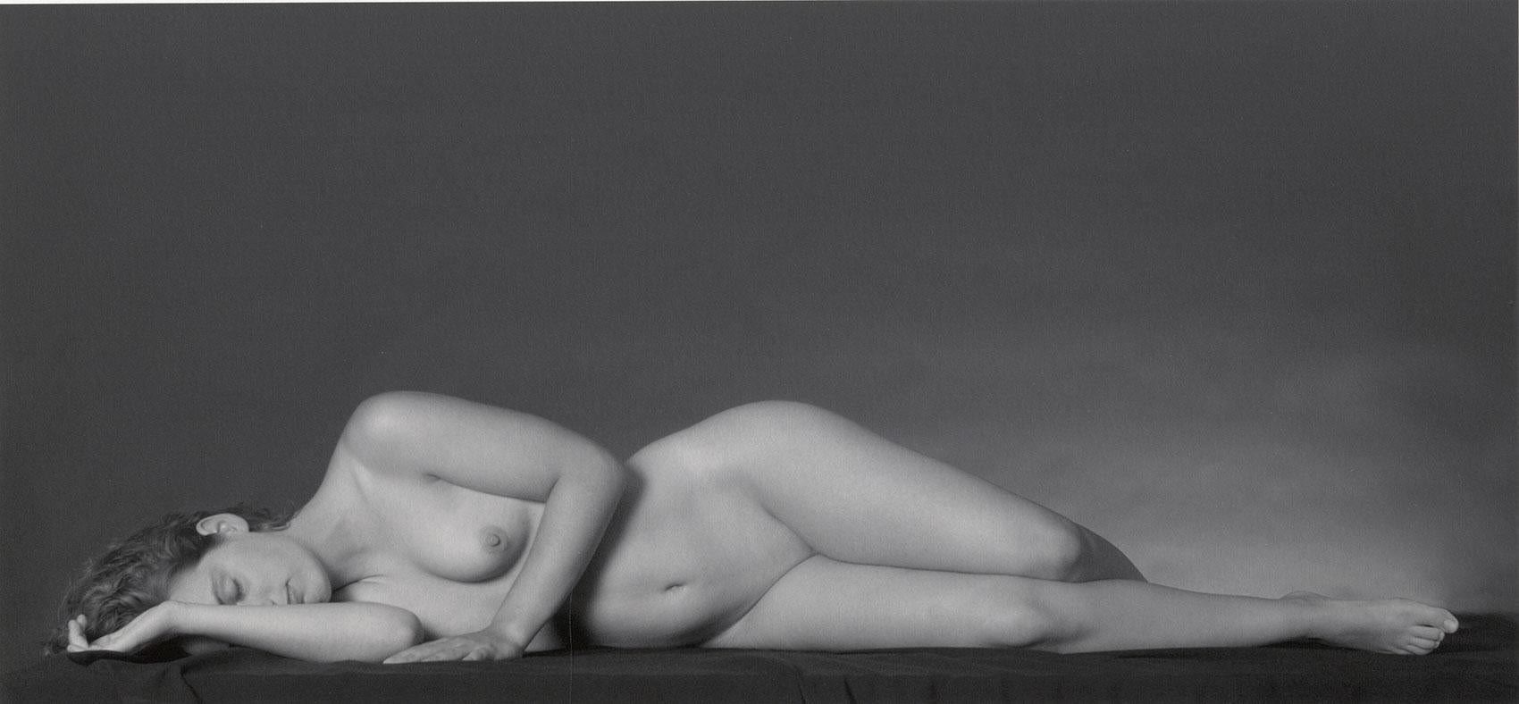 Eric Kellerman (b. 1944) Figurative Photograph - Lying Nude (Long-legged full frontal female nude lying prone on her right side)