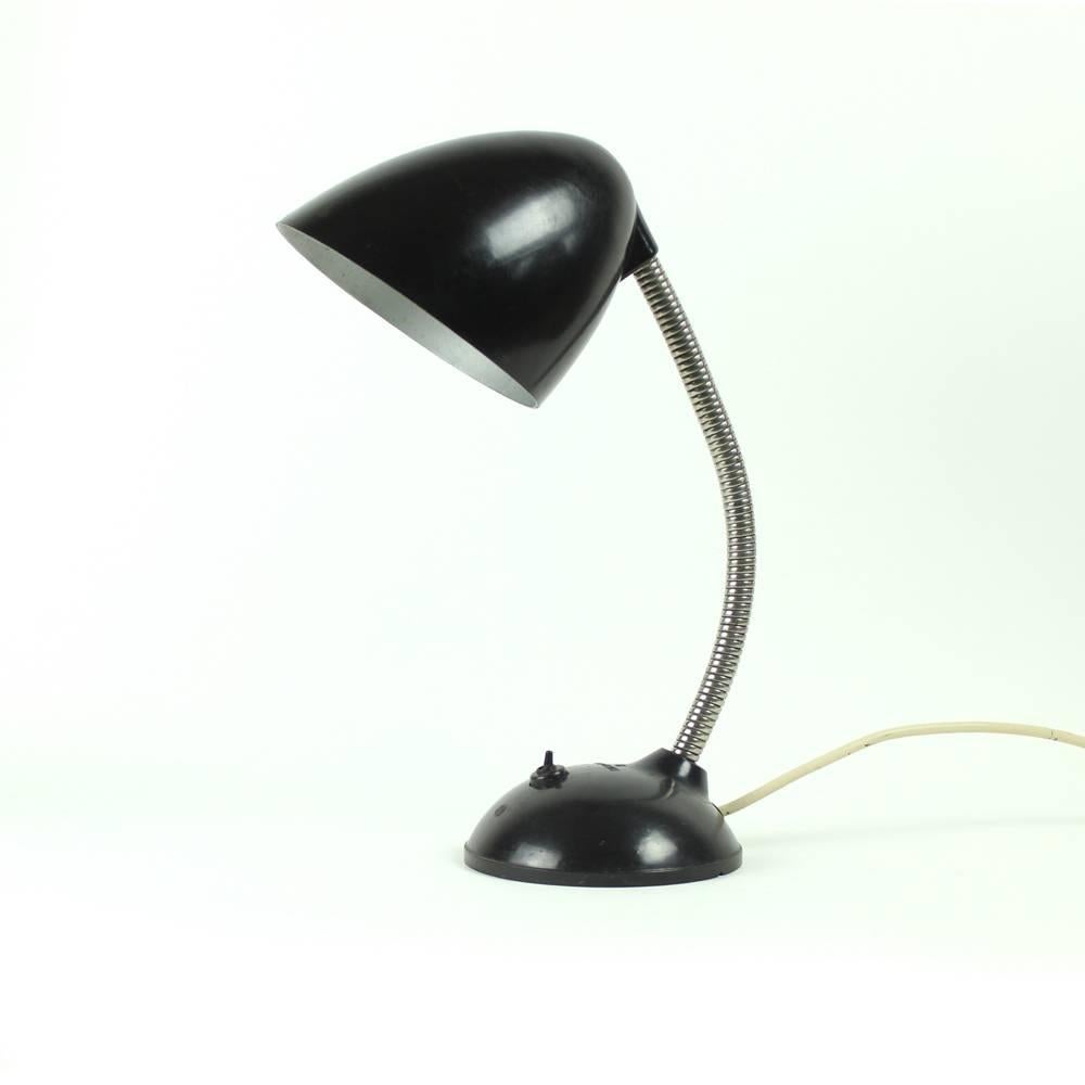 Iconic Industrial table lamp by Eric Kirkman Cole. Gooseneck and black bakelite body and shield. Model type 11.105 model. Very good condition with some wear on bakelite.