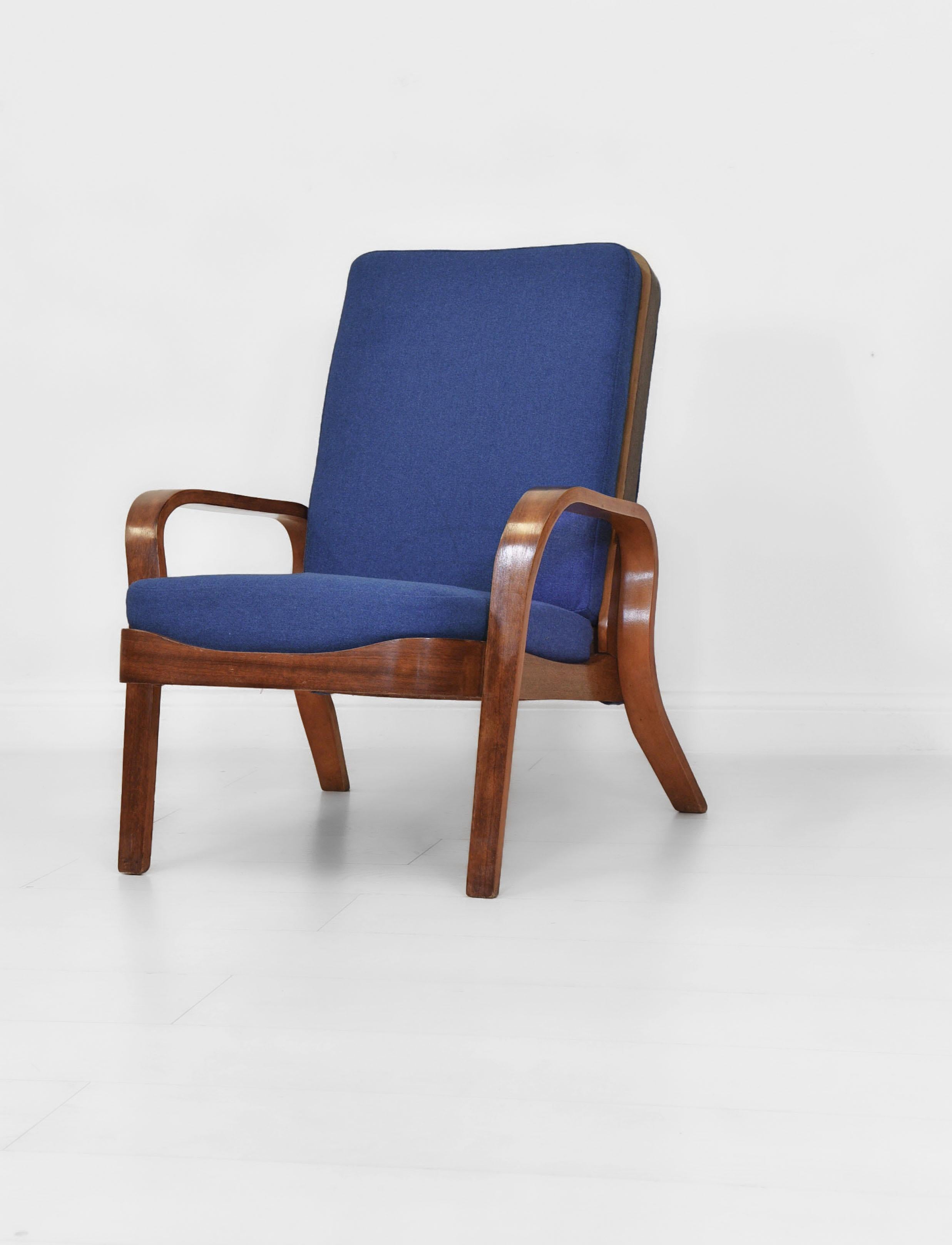 Modernist bent-ply armchair by British designer and architect Eric Lyons (1912–1980). circa late 1940s.

Made by Packet Furniture, the armchair has recently been re-covered in a textured royal blue fabric with new medium to soft foam cushions. The