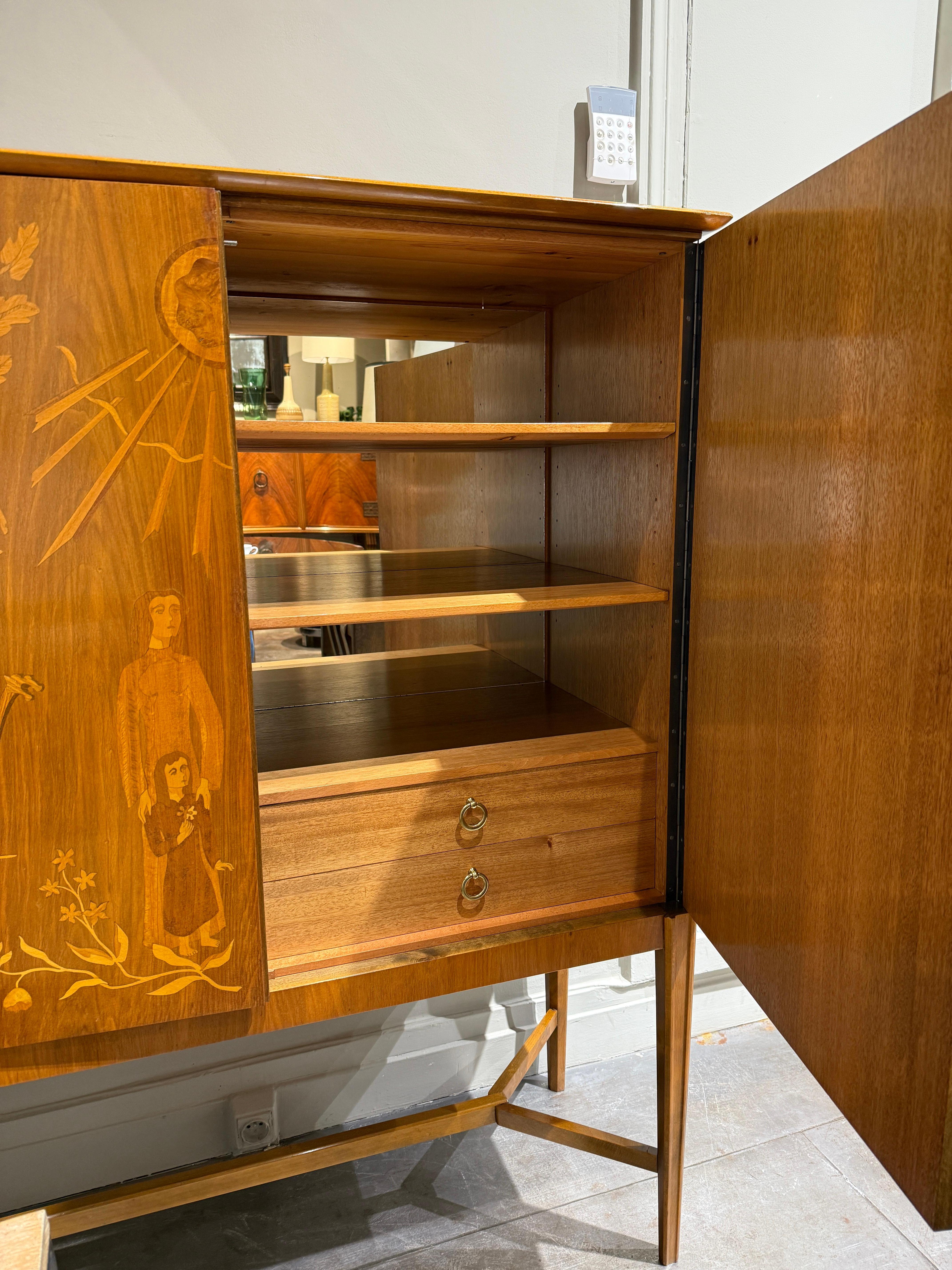 Beautiful cabinet circa 1940 attributed to Erik Matsson 
Stained beech with walnut intarsia decor 
Beautiful condition 
Key included 
