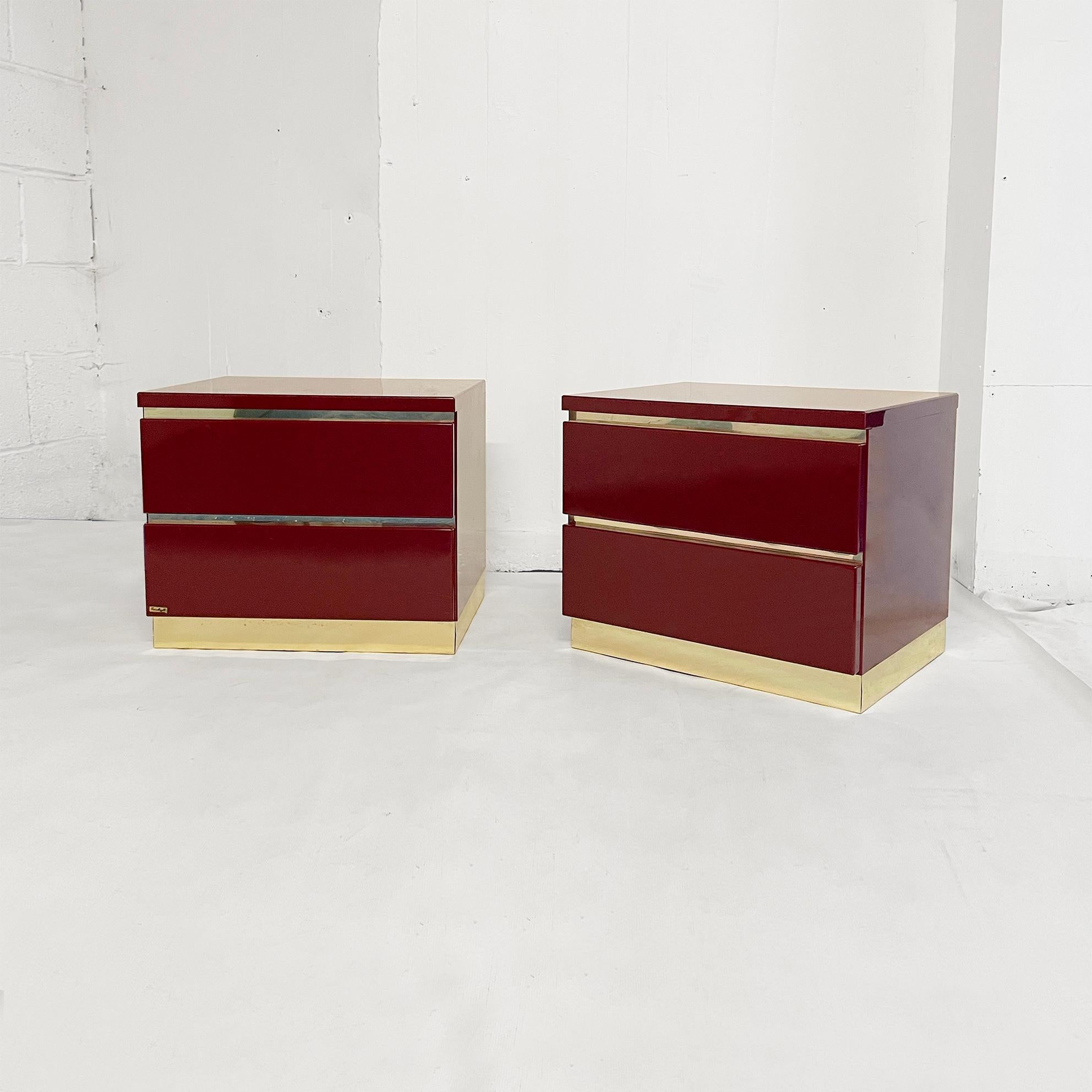 An exquisite bedside tables set by the French 1970s designer Eric Maville in deep burgundy and brass. This signed French import consists of a pair of bedside tables/drawers( a double bed in burgundy acrylic with brass trim also available).

This set