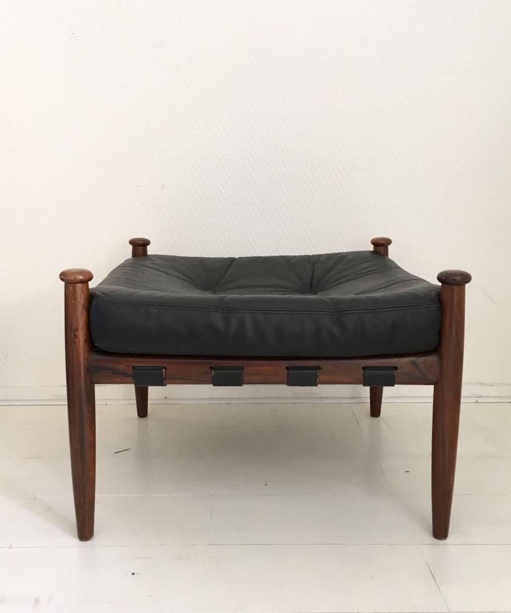 This black leather and rosewood ottoman was designed circa the 1960s for Ire Mobler in Sweden. The leather cushion features a zipper underneath. Exclusive Scandinavian design with minimal signs of age and use.