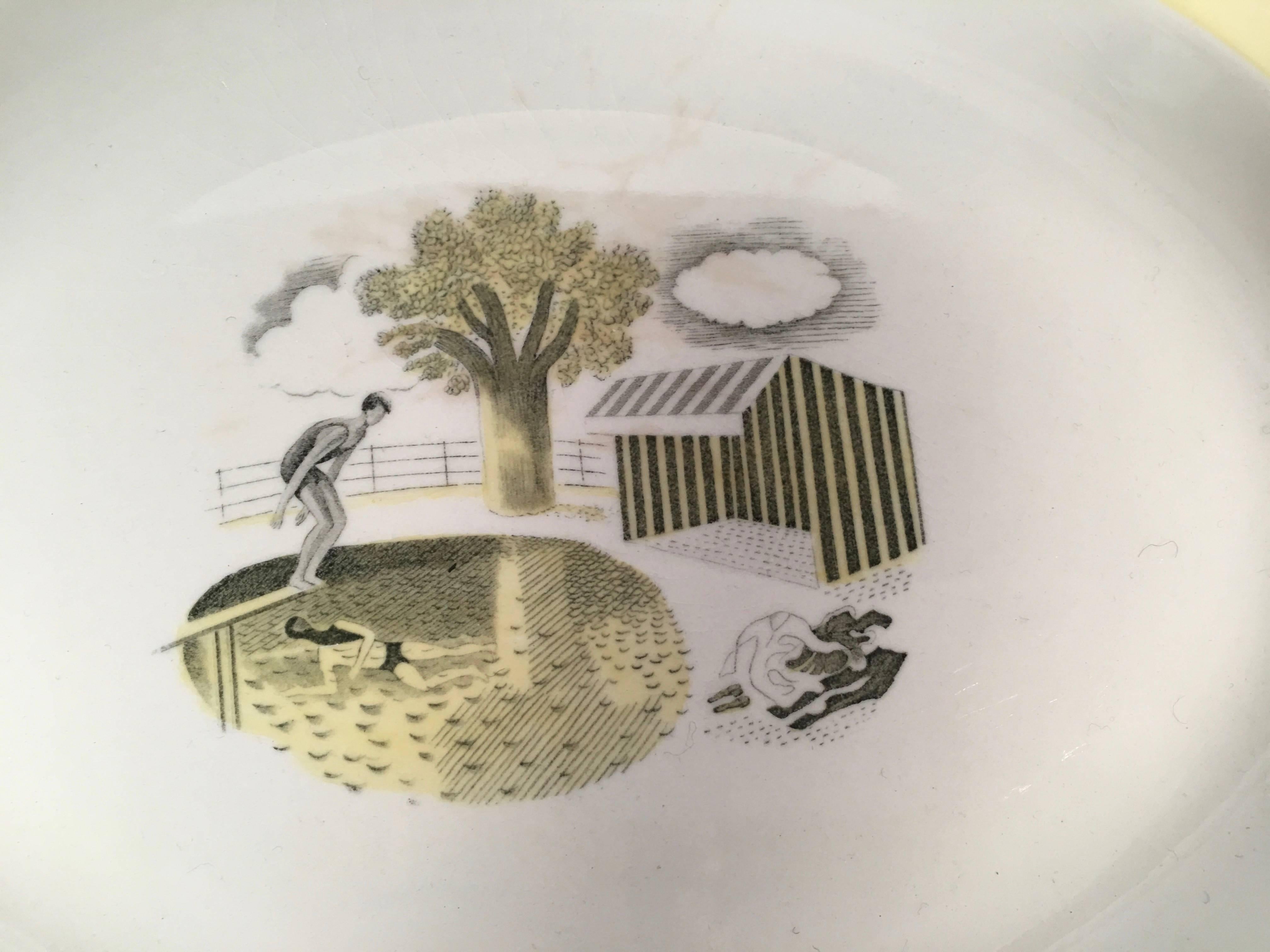 A rare Eric Ravilious designed oval platter for Wedgwood from the Garden Series, depicting a swimmer about to dive into a pool, above another swimmer who is underwater, next to a striped canvas cabana with their clothes nearby, in transfer printed