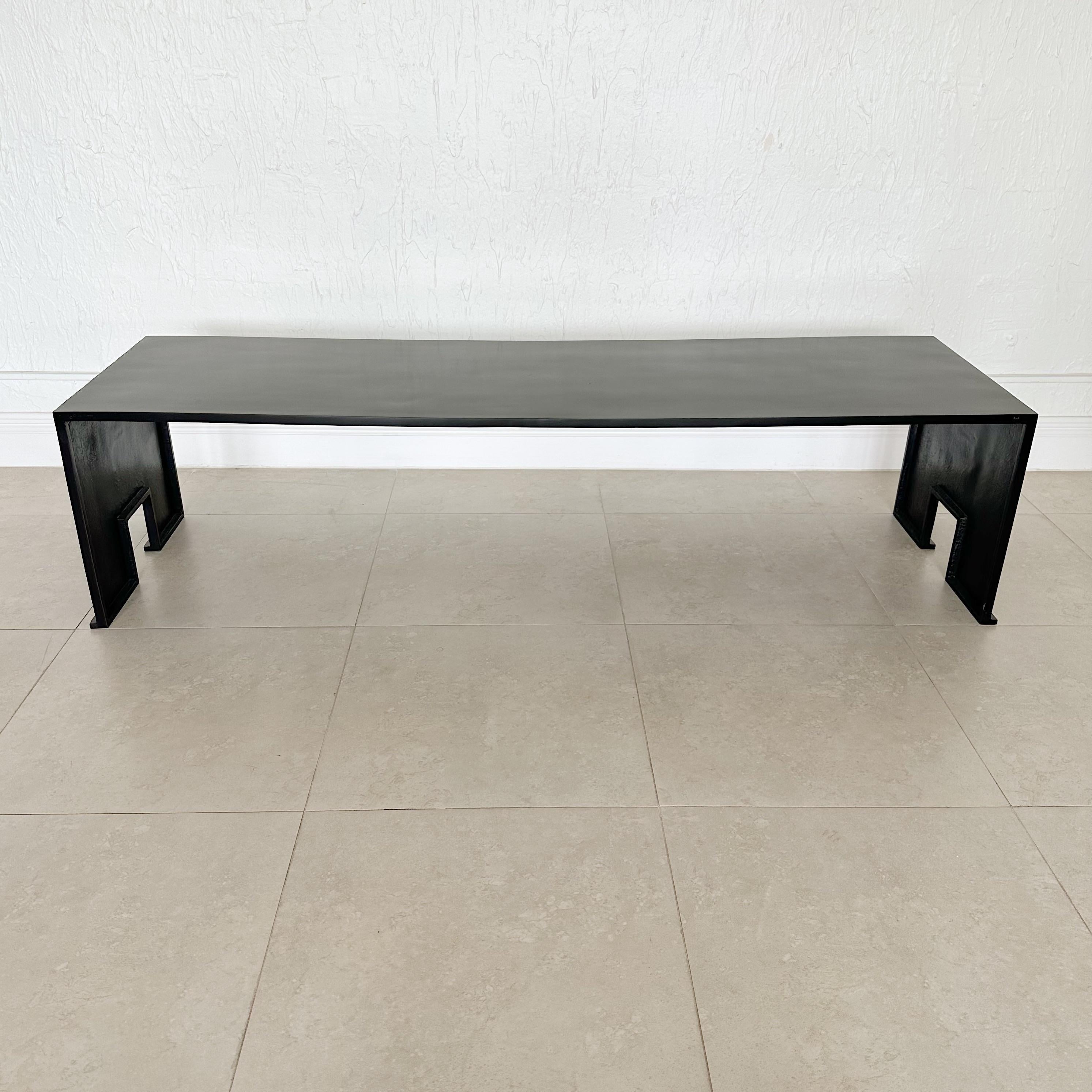 Solid bronze coffee table with a waxed black patina finish. Designed by Eric Schmitt for Christian Liaigre.
This table came in two finishes, smooth and hammered, this is the smooth version, and also the larger version. 
Circa 1998 Signed, Virgile ES