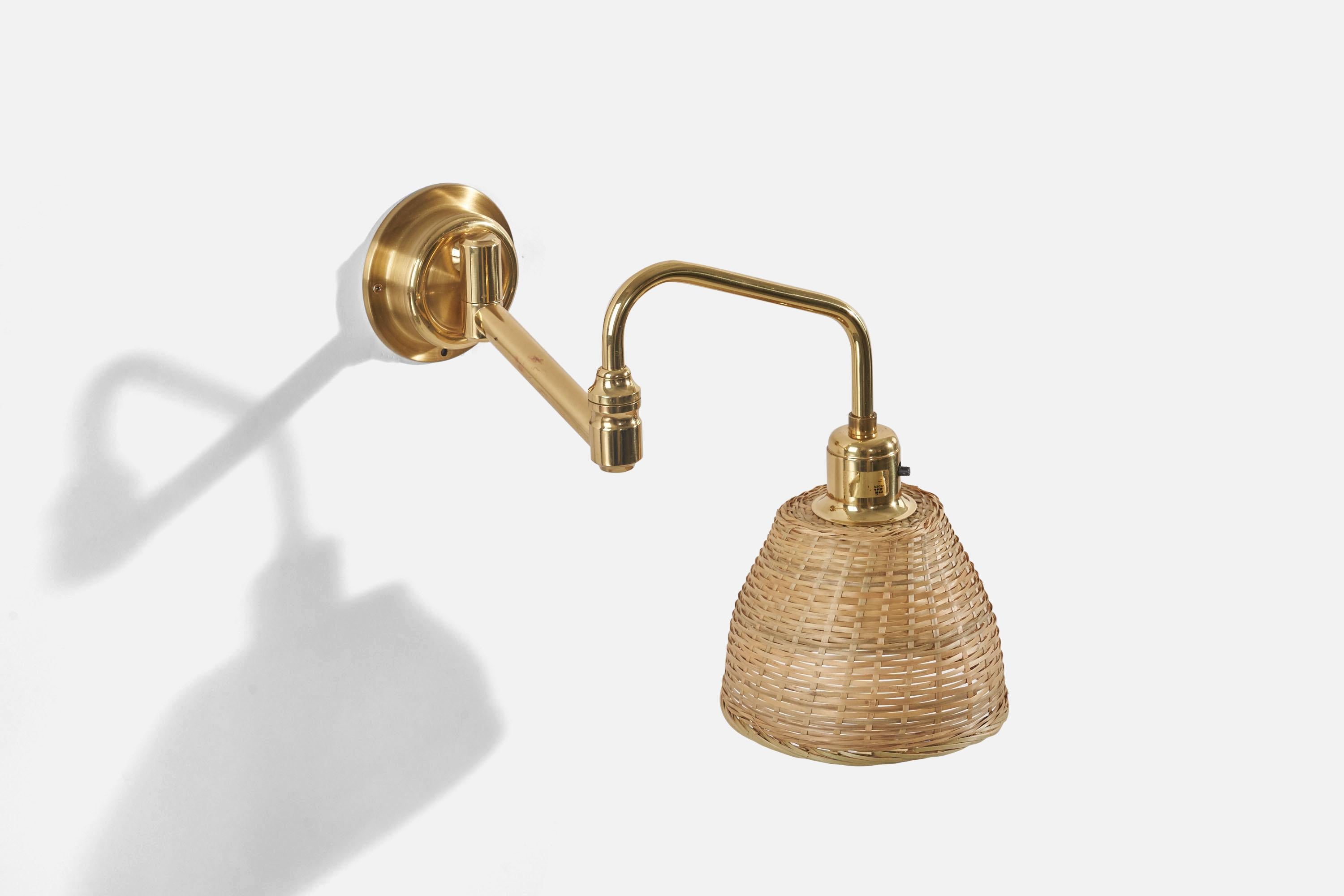 A brass and rattan wall light designed by Eric Wärnå and produced by EWÅ Wärnamo, Sweden, c. 1960s. With makers label.

Sold with Lampshade(s). Dimensions stated are of Sconce with Shade(s).

Dimensions variable, measurements listed are at the