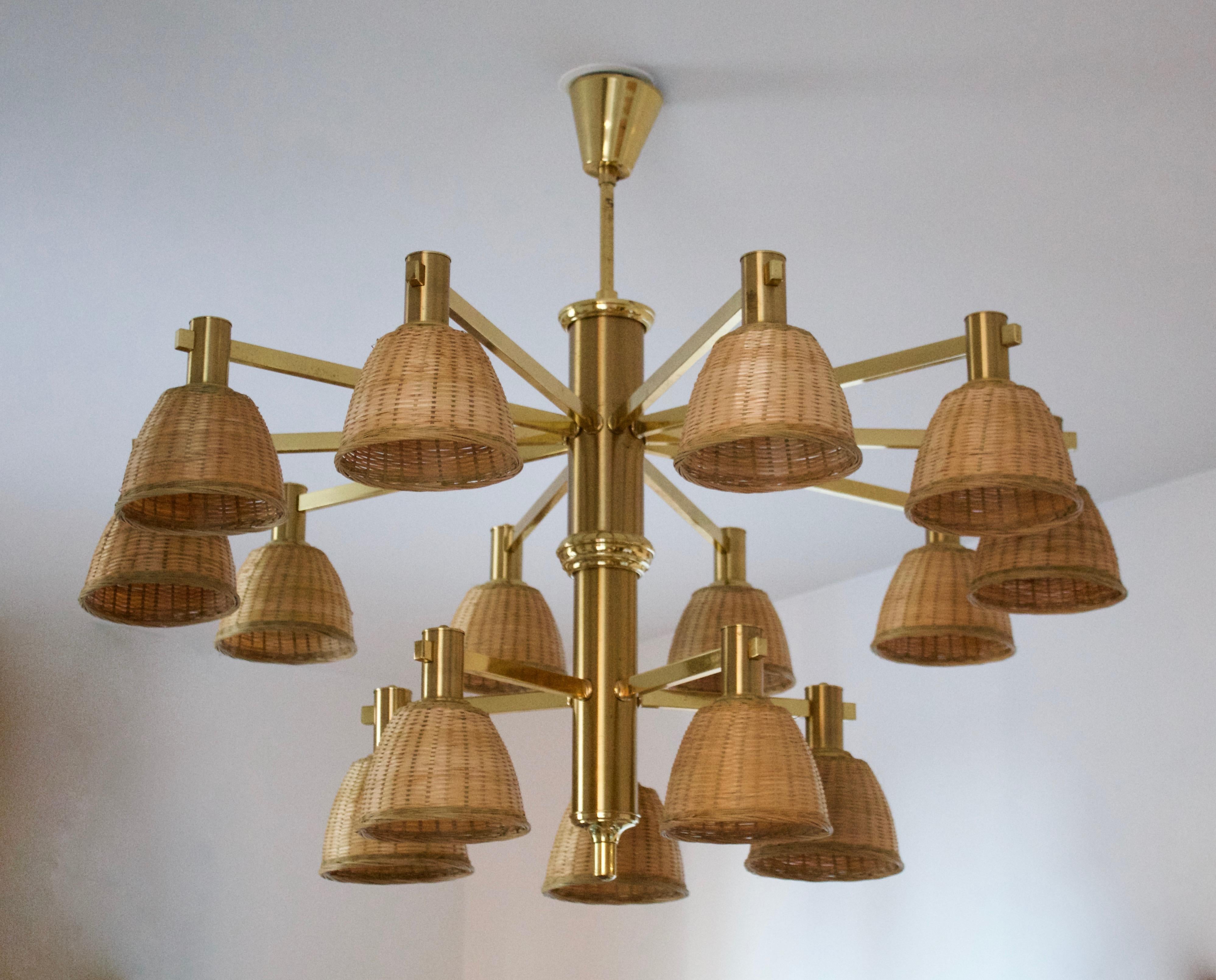 A sizable 15-Armed Chandelier. Designed and production attributed to Eric Wärnå, for EWÅ Värnamo, Sweden, c. 1960s. Assorted vintage rattan lampshades. Originally produced with glass lampshades.

Other designers of the period include Hans-Agne