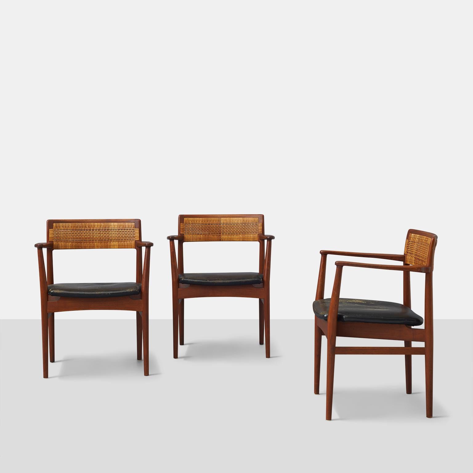 A trio of W26 armchairs by Eric Worts for Henrik Worts. Cane backs and black leather seats.