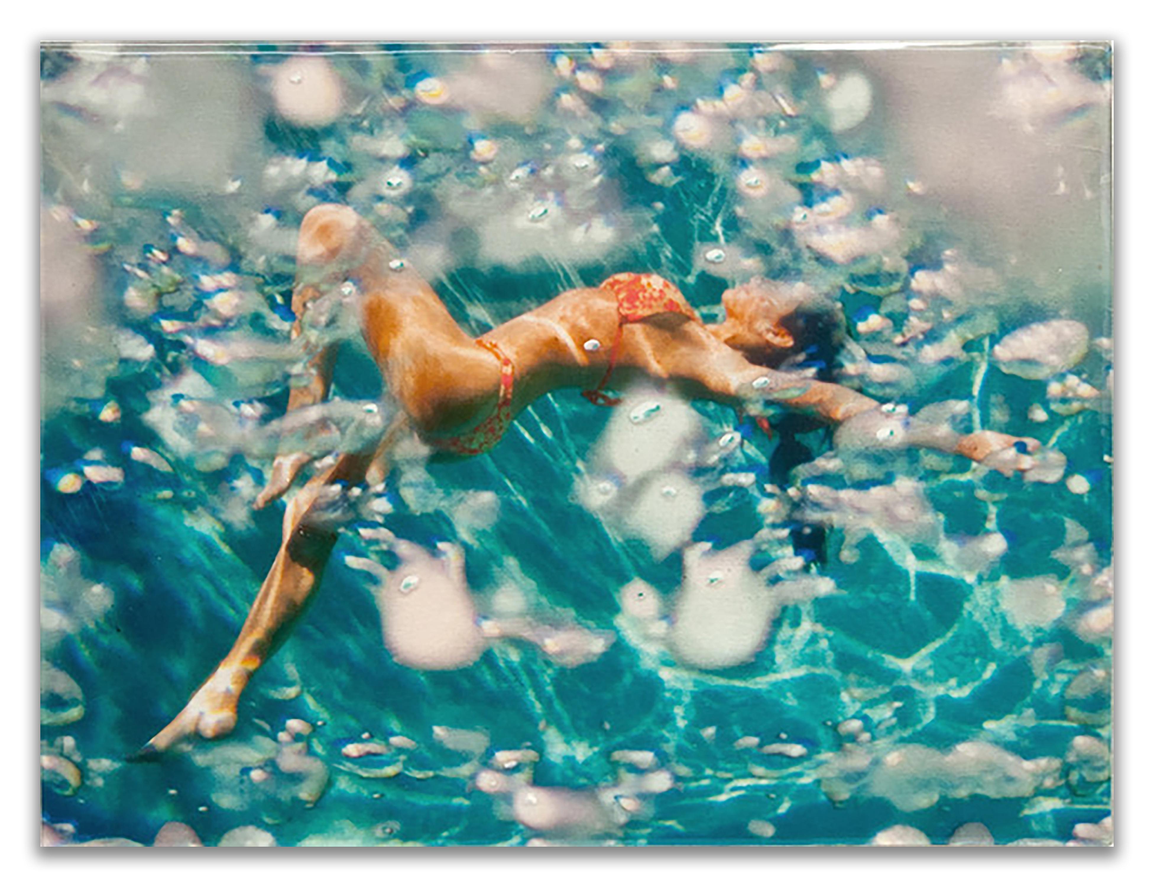 "Joy" 
18 x 24 inches
Unique

Photo transparency with resin, paint and silver or gold leaf, on a wood panel. 

Eric Zener (b. 1966) is a self-taught photorealist artist recognized for his figure paintings of lone subjects often submerged in swimming