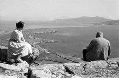 Man and woman sitting on a cliff at the island of Delos, Greece 1950s