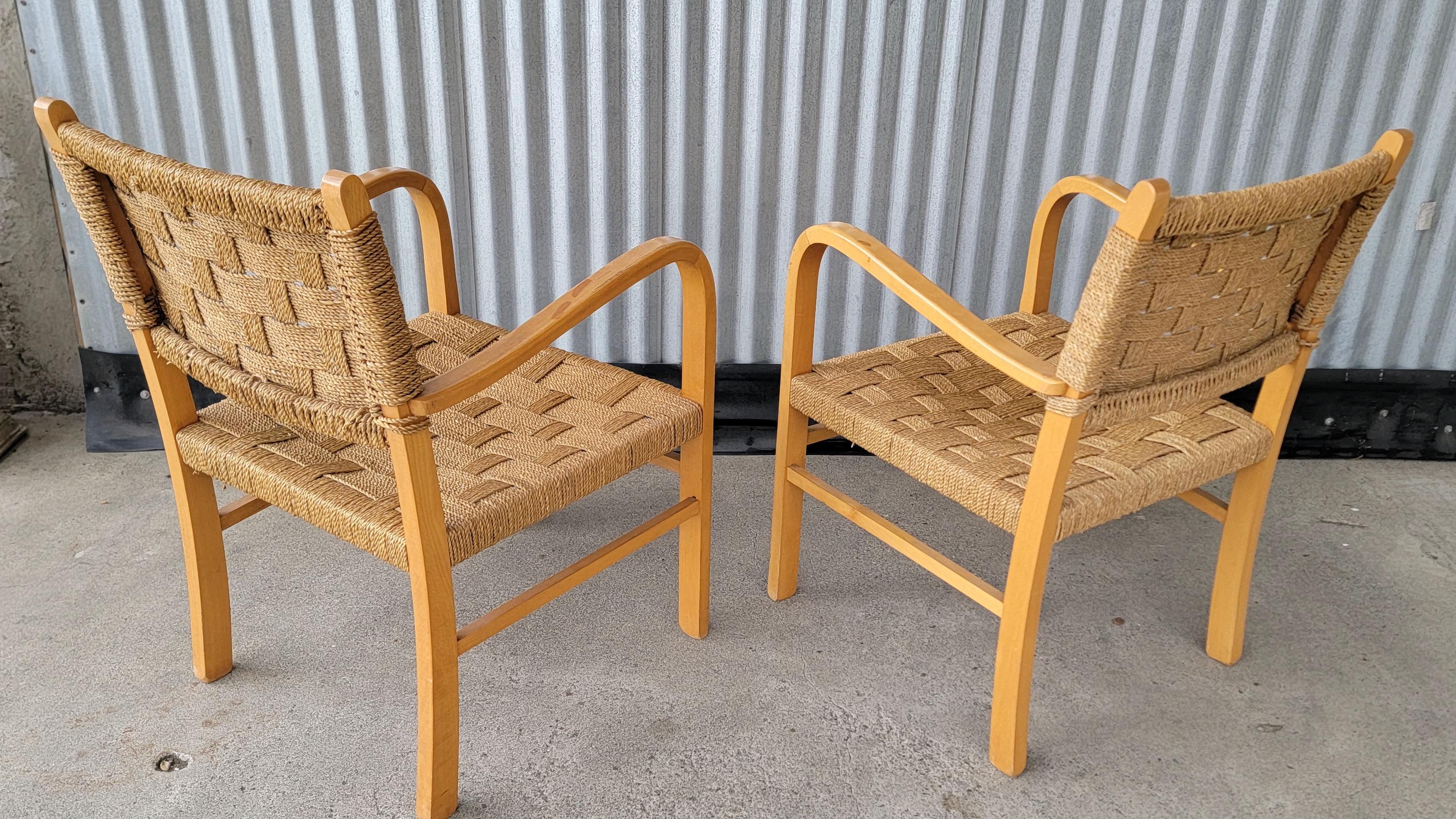 A pair of curved beech wood and sea grass rope Bauhaus armchairs attributed to Erich Dieckmann for Vroom & Dreesman. Germany circa. 1930. Very good original finish, structurally solid. Mild wear to finish from age and use.